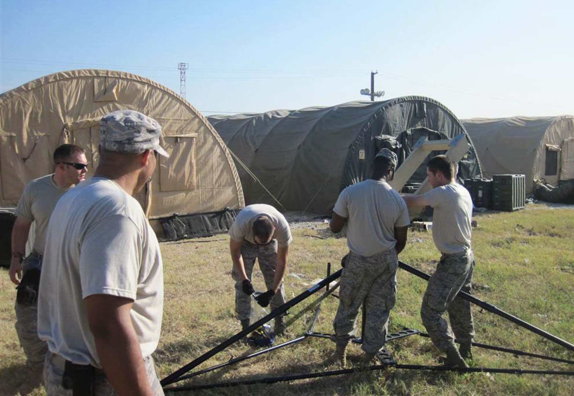 5th Combat Communications Group members (from left) Tech. Sgt. Turvon Casey, Senior Airman Travis Meyer, Staff Sgt. Trenton Morgan, Staff Sgt. Jarrell Williams and Senior Airman Thomas Williams, set up the USC-60 Satellite dish used to provide voice and data communications for medical personnel of the 24th Expeditionary Medical Support unit. Courtesy photo