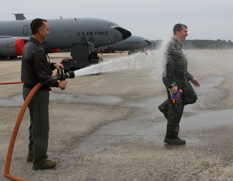 Maj. Vecchione, a pilot with the 911th Air Refueling Squadron, is hosed down by. Lt. Col. Bill Uptmor, 911th commander, upon finishing his final KC-135R flight with the 916th Air Refueling Wing. (courtesy photo)