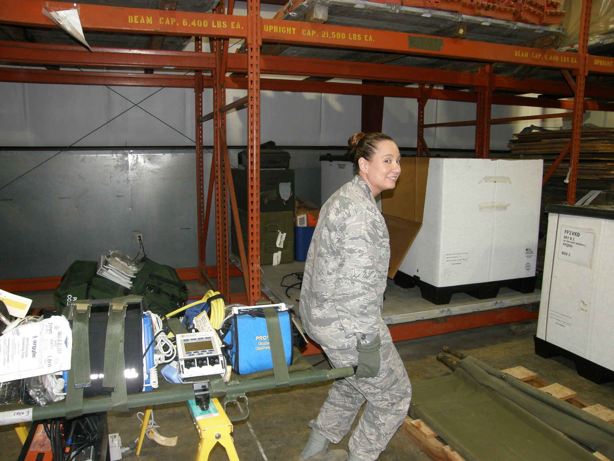 WRIGHT-PATTERSON AIR FORCE BASE, Ohio – First Lt. Shannon Simon, 445th Aeromedical Evacuation Squadron, loads equipment to be used for a future AE mission in support of Operation Unified Response. The 445th AES sent a five-person crew consisting of two flight nurses and three AE technicians; and three AE ground crew members to MacDill Air Force Base to support the on-going relief efforts in Haiti. (Courtesy photo)