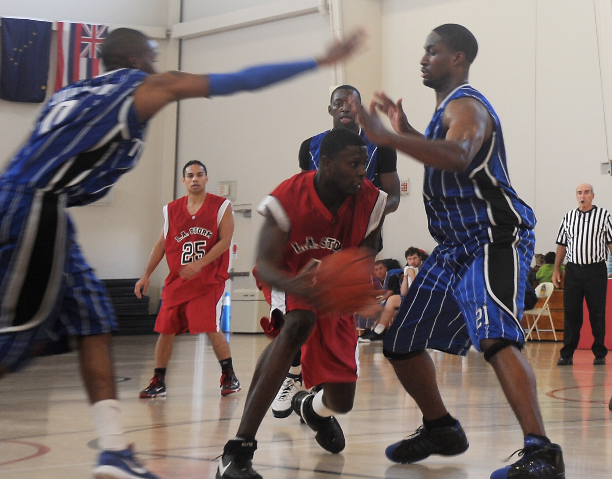 Airman First Class Caleb Chandler (left), 61st Medical Group, drives the lane against defenders from Travis Air Force Base during the championship final game. Los Angeles AFB sponsored the 2009 Veterans Day "SoCal Shootout" Basketball Tournament on Nov. 7 and 8, which included participation from Luke AFB, Travis AFB, Vandenberg AFB, and Edwards AFB. The LA Storm won the championship title with an 80 to 77 victory over Travis. (Photo by Atiba Copeland)