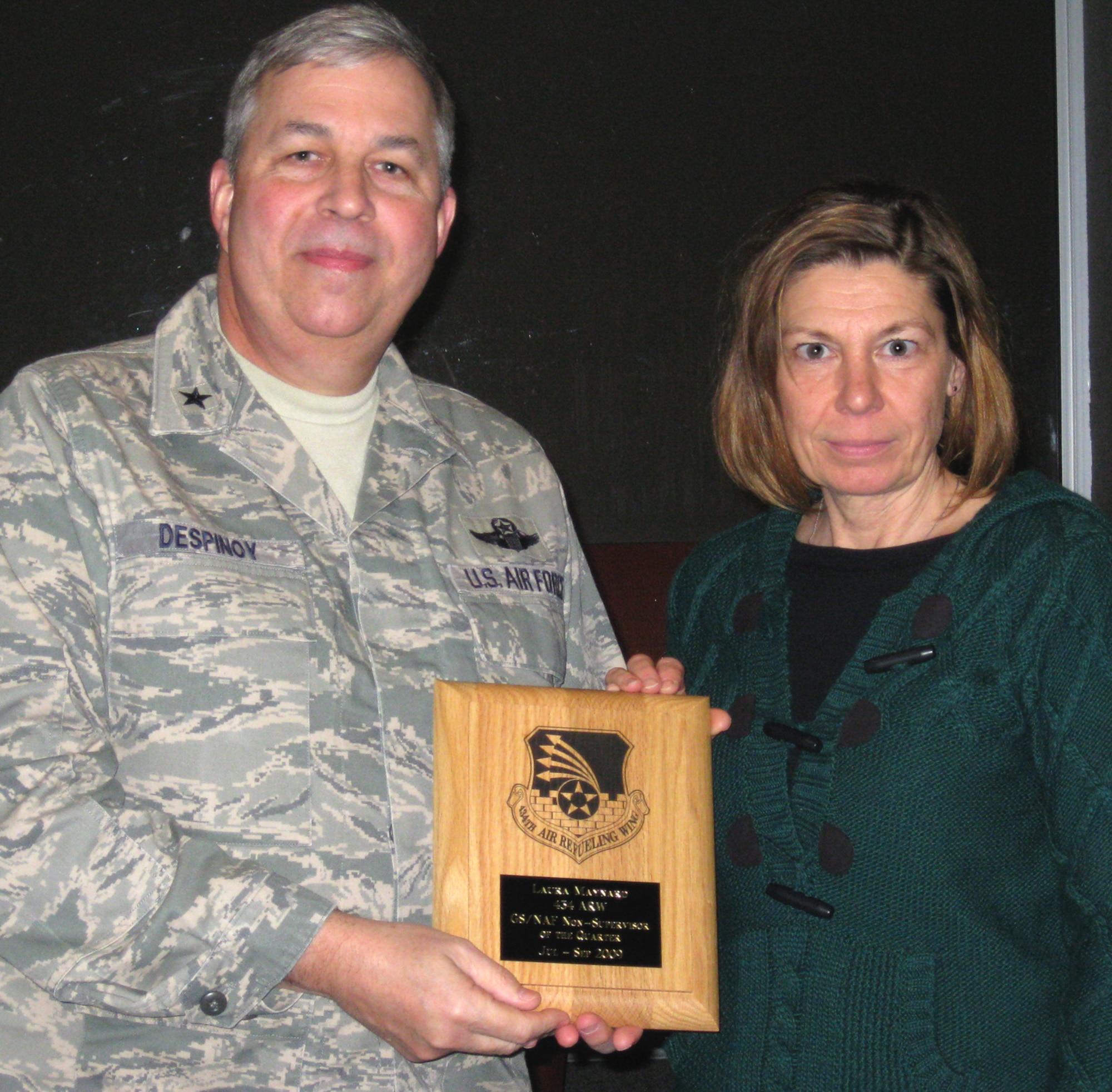 GRISSOM AIR RESERVE BASE, Ind., -- Brig Gen. Dean Despinoy, 434th Air Refueling Wing commander, presents Laura Maynard, a staffing specialist with the civilian personnel office,  a plaque recognizing her as Grissom's GS/NAF non-supervisor of the quarter . The presentation was made during a civilian commander's call held recently. (U.S. Air Force photo/Tech. Sgt. Doug Hays)