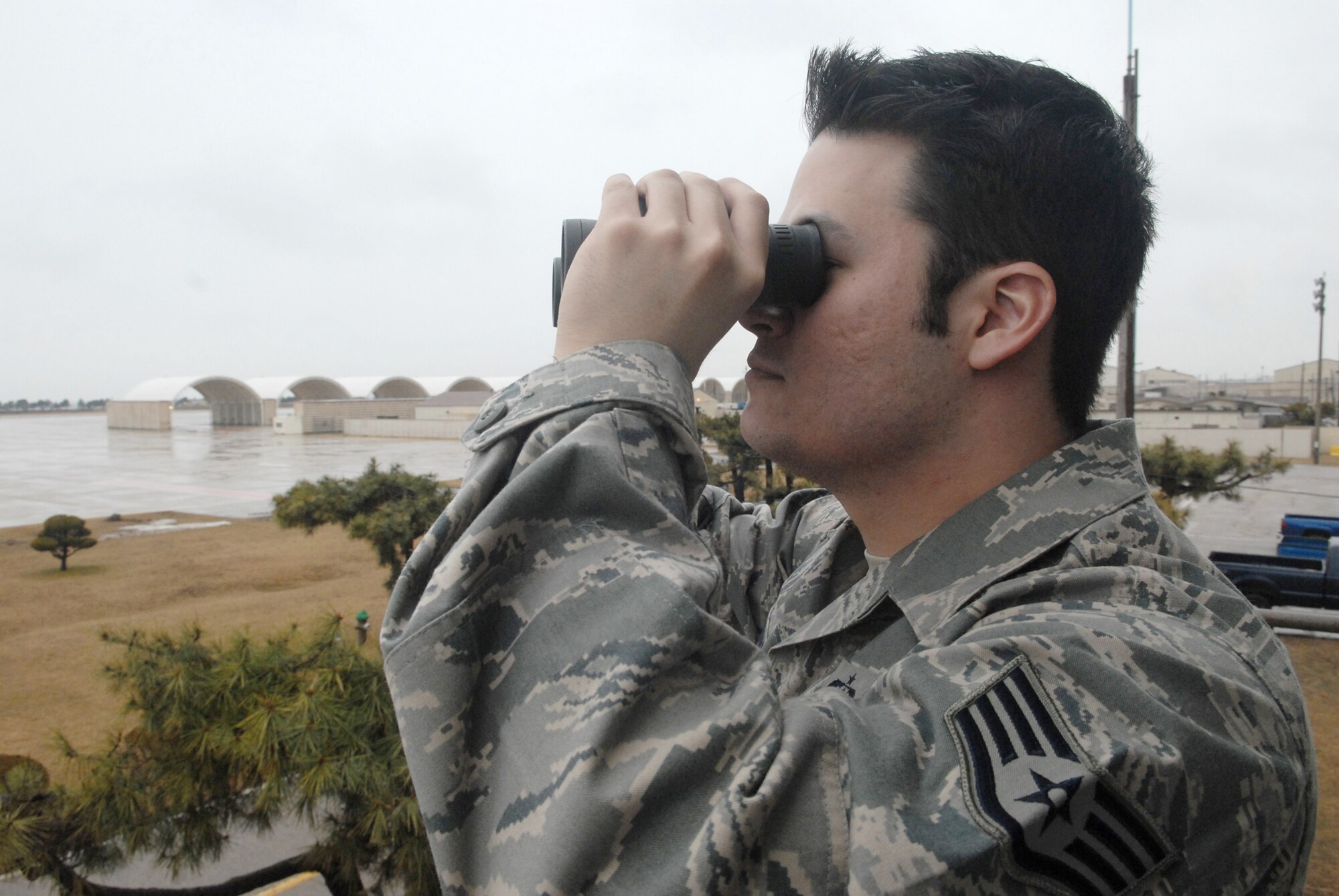 Staff Sgt. Jack Cotham observes weather conditions on the flight line Feb. 11, 2010 at Kunsan Air Base, South Korea. Sergeant Cothan is a 8th Operation Support Squadron weather forecaster. (U.S. Air Force photo/Senior Airman Roy Lynch)