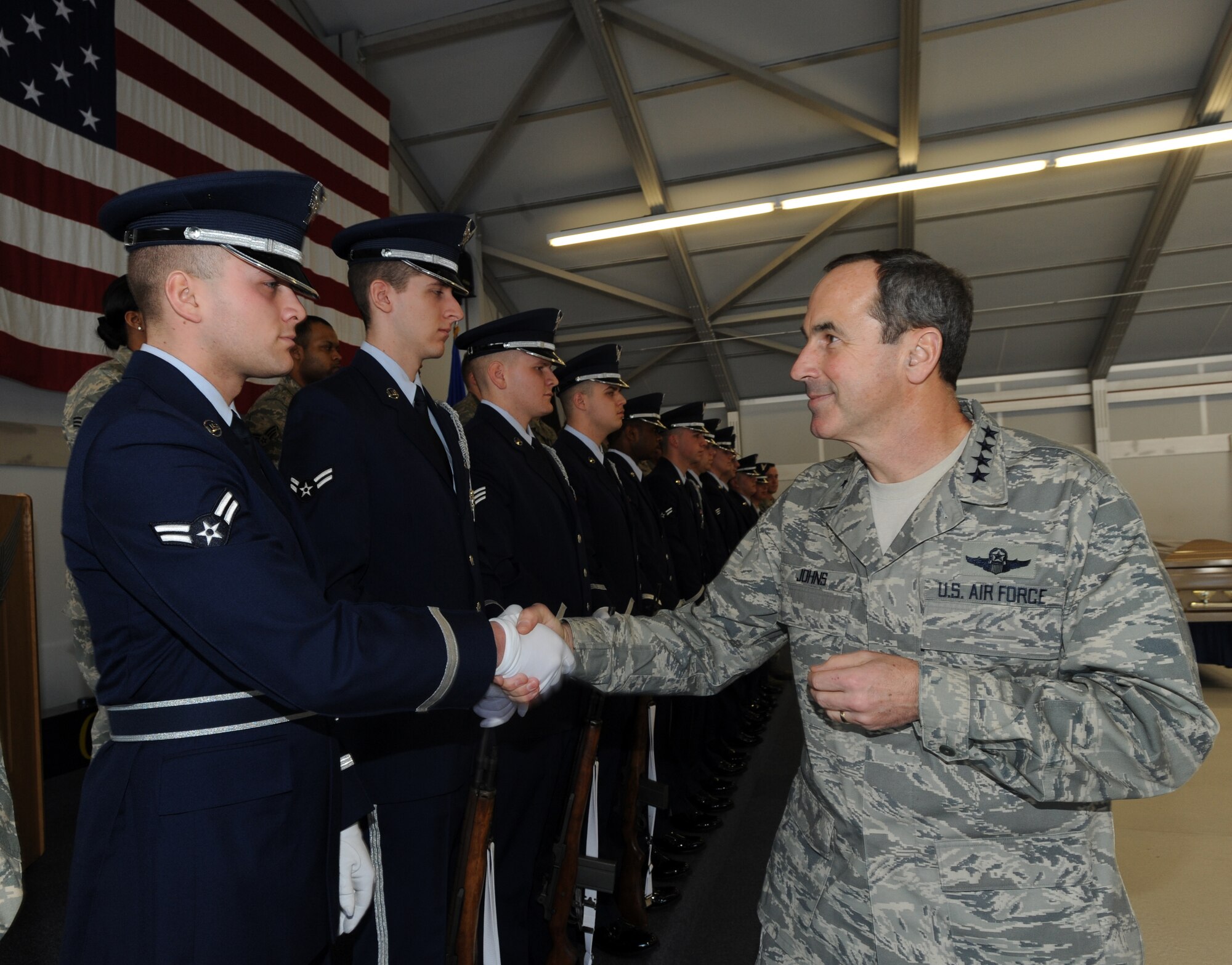 Gen. Raymond E. Johns Jr., commander of Air Mobility Command, greets Airman 1st Class Nathan DeSantis, a 319th Logistics Readiness Squadron vehicle operator and Honor Guard ceremonial guardsman, during a visit to the 319th Air Refueling Wing Honor Guard Feb. 10.
