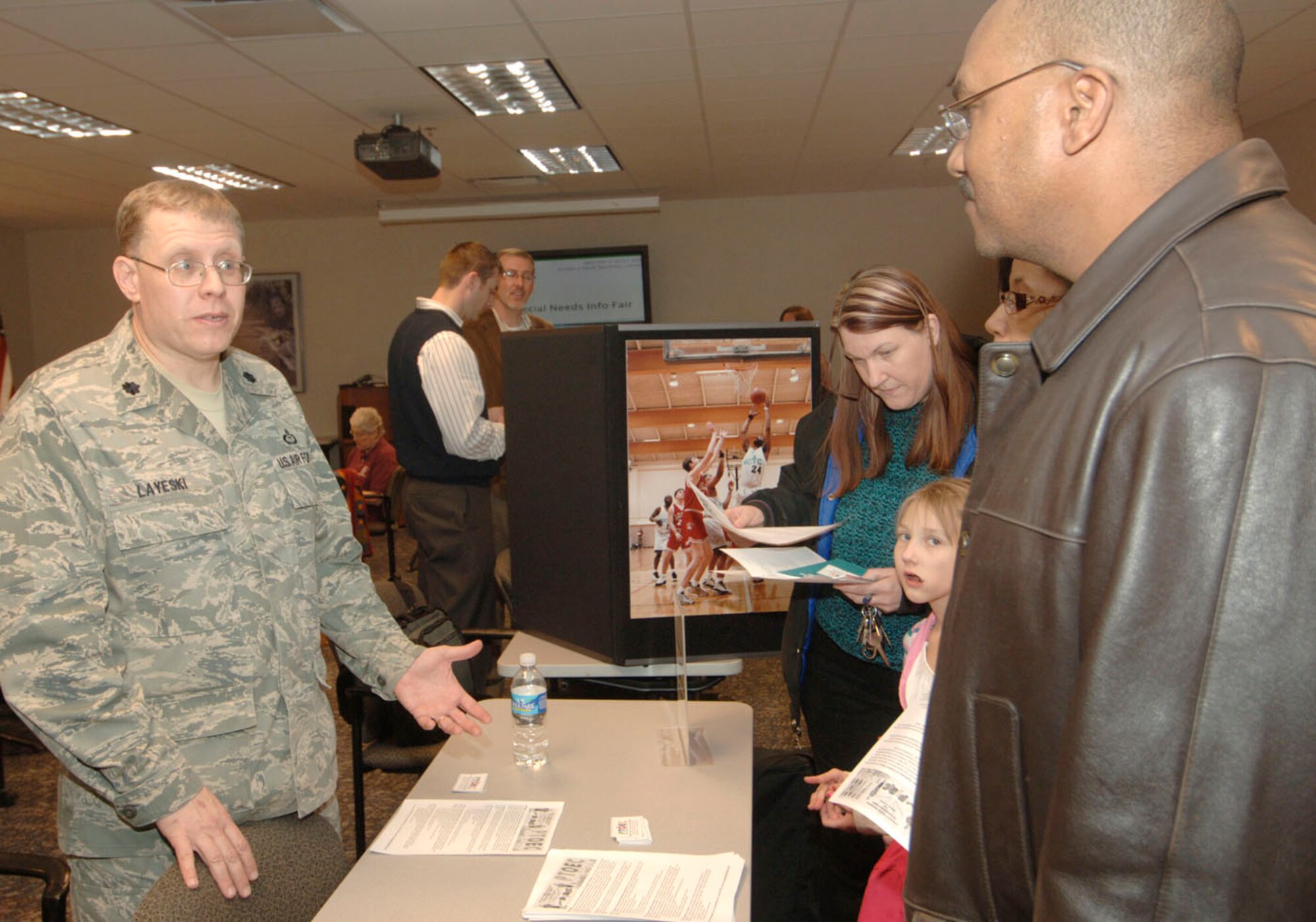 SCOTT AIR FORCE BASE, Ill. -- As a father of a 15-year-old son with autism, Lt. Col. Gene Layeski, Air Mobility Command, explains how the Parent and Teacher Organization for Exceptional Children, a foundational sporting coalition that feeds into the Special Olympics program, has helped his own son and many other children with special needs be able to participate in sporting programs.  More than 20 helping agencies were available Feb. 11 to discuss their services during an special needs information fair hosted by the Airman and Family Readiness Center. (U.S. Air Force photo by Karen Petitt)