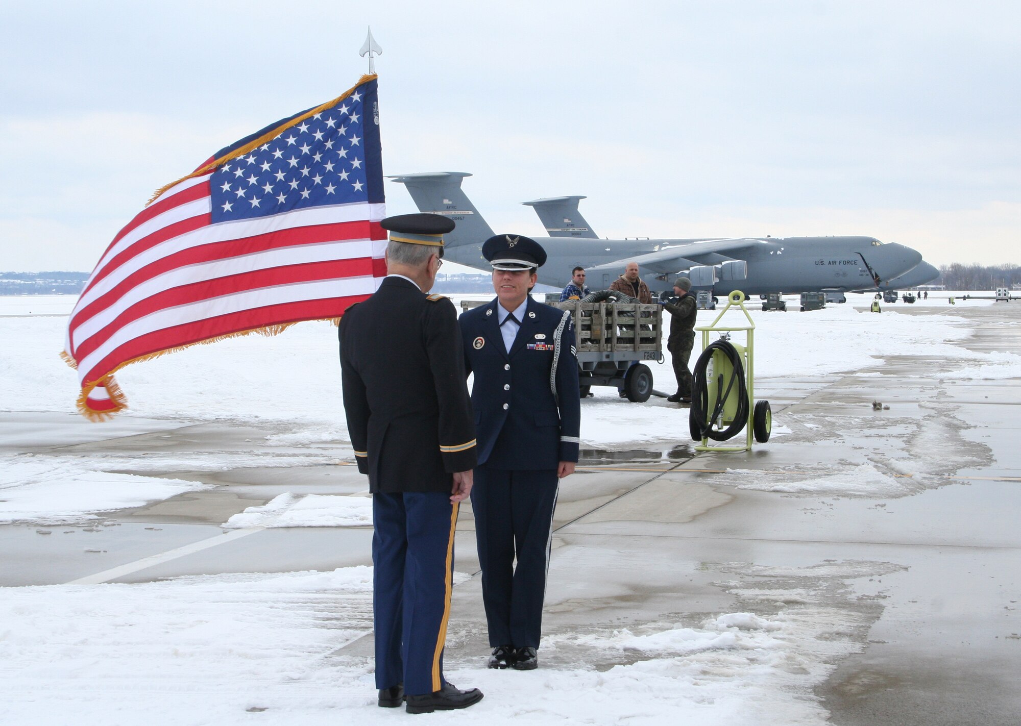 WRIGHT-PATTERSON AIR FORCE BASE, Ohio – Senior Airman Carol Walker, 88th Forces Support Squadron, ceremonial guardsman with the base honor guard, received the Oath of Enlistment from her paternal grandfather; Col. (retired) Jacob Close, a World War II veteran who served 32 years in the Army infantry, in front of a C-5 Galaxy from the 445th Airlift Wing. (U.S. Air Force photo/Stacy Vaughn)