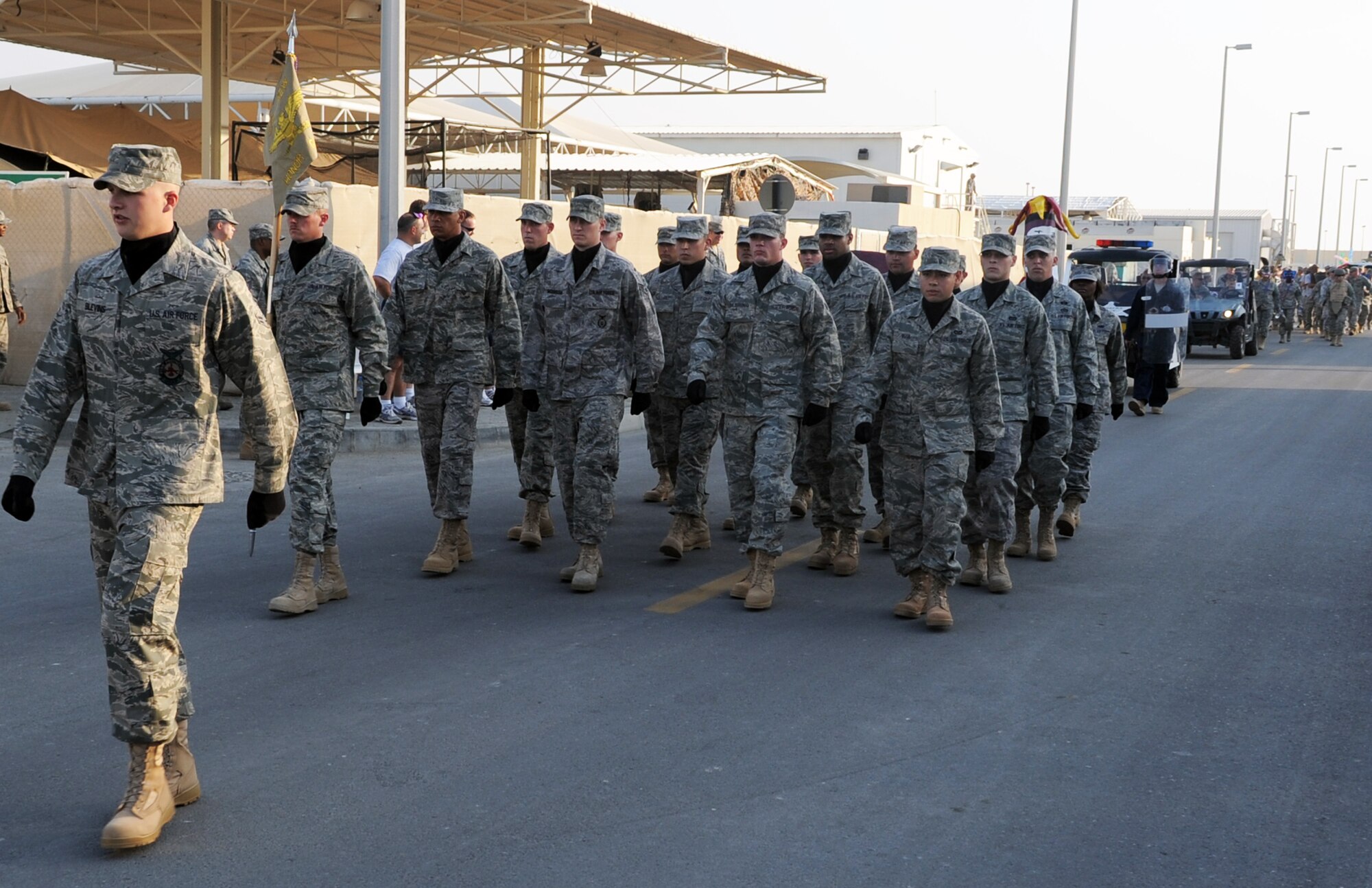Airmen from the 380th Air Expeditionary Wing Honor Guard march in formation for the wing Mardis Gras parade Feb. 16, 2010, at a non-disclosed location in Southwest Asia.  The wing's honor guard is a mixture of Airmen from across the wing who volunteer any extra time they have to be a part of the group that particiaptes in official functions and events across the wing. (U.S. Air Force Photo/Master Sgt. Scott T. Sturkol/Released)
