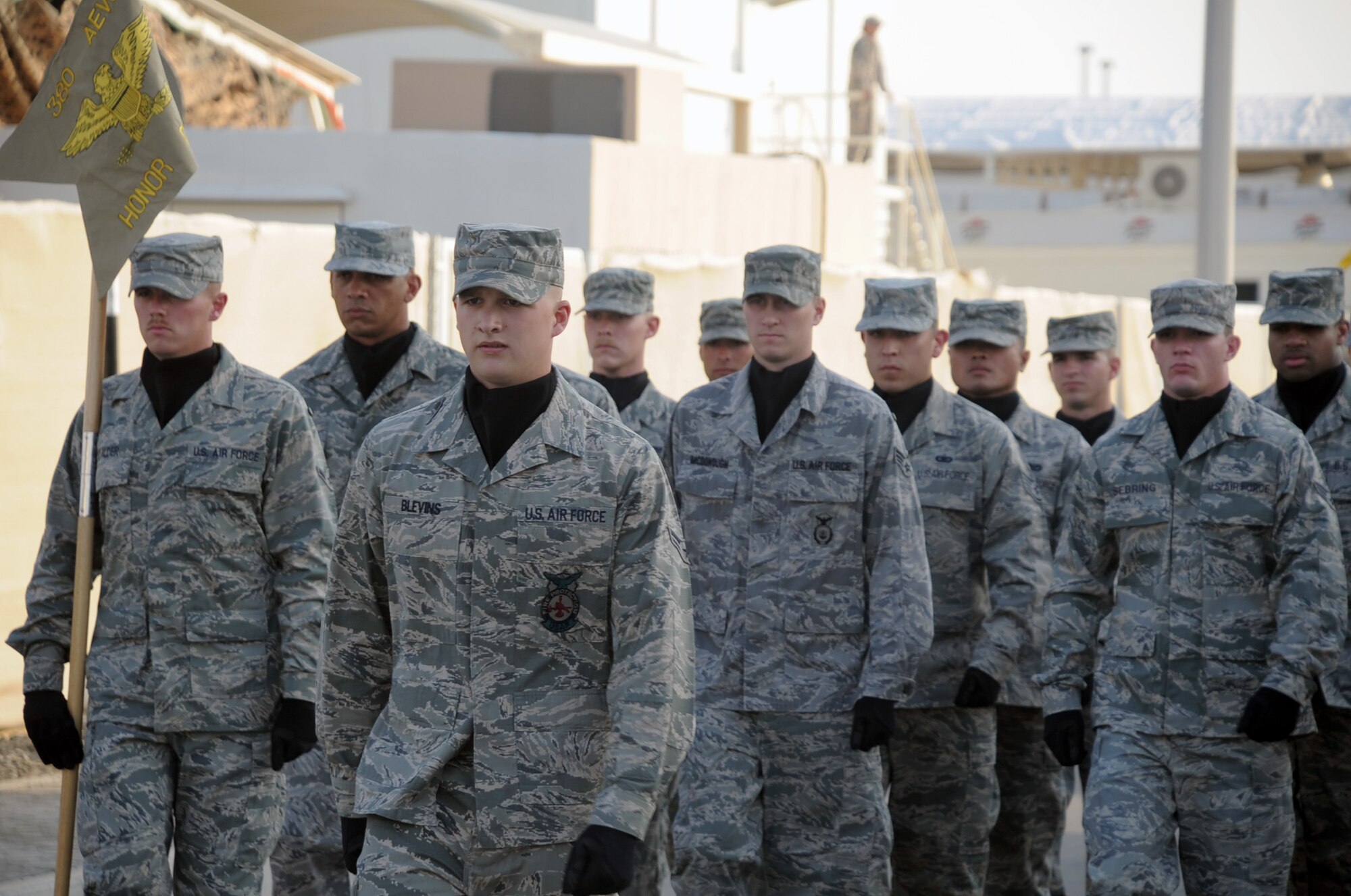 Airmen from the 380th Air Expeditionary Wing Honor Guard march in formation for the wing Mardis Gras parade Feb. 16, 2010, at a non-disclosed location in Southwest Asia.  The wing's honor guard is a mixture of Airmen from across the wing who volunteer any extra time they have to be a part of the group that particiaptes in official functions and events across the wing. (U.S. Air Force Photo/Master Sgt. Scott T. Sturkol/Released)