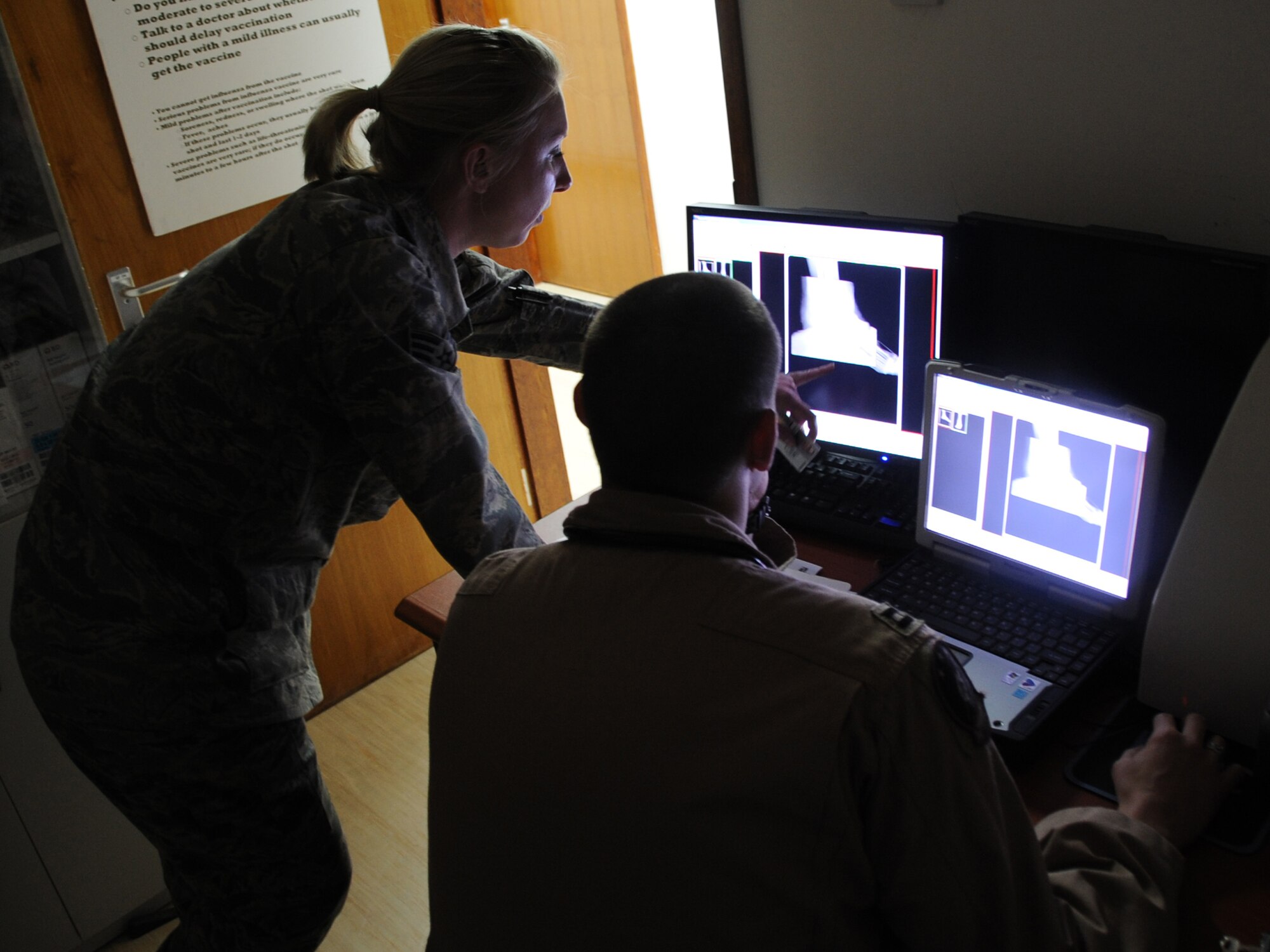 Senior Airman Shara Fuentes, 380th Expeditionary Wing Medical Group medical technician assist Capt. Daniel Pascucci, 965th Expeditionary Airborne Air Control Squadron flight surgeon with an x-ray at an undisclosed location in Southwest Asia on Feb 15, 2010. The 380th AEW is comprised of four groups and 12 squadrons and the wing's deployed mission includes air refueling, surveillance, and reconnaissance in support of overseas contingency operations in Southwest Asia. The wing supports Operation Iraqi Freedom, Operation Enduring Freedom and the Combined Joint Task Force-Horn of Africa. (U.S. Air Force photo/Senior Airman Jenifer H. Calhoun/Released)
