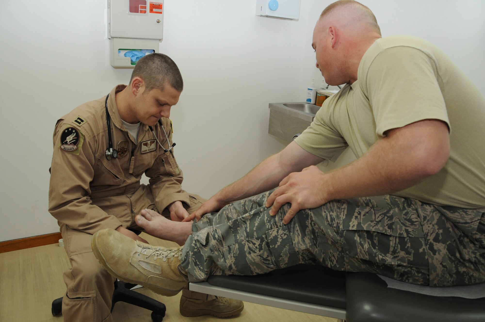 Capt. Daniel Pascucci, 965th Expeditionary Airborne Air Control Squadron flight surgeon examines a patient at an undisclosed location in Southwest Asia on Feb 15, 2010. The 380th AEW is comprised of four groups and 12 squadrons and the wing's deployed mission includes air refueling, surveillance, and reconnaissance in support of overseas contingency operations in Southwest Asia. The wing supports Operation Iraqi Freedom, Operation Enduring Freedom and the Combined Joint Task Force-Horn of Africa. (U.S. Air Force photo/Senior Airman Jenifer H. Calhoun/Released)
