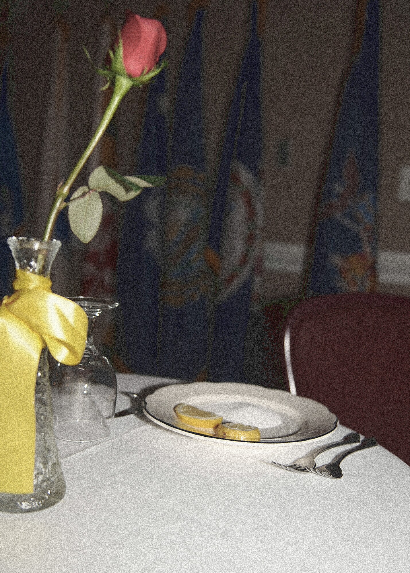 At a round table stands a lone place setting that honors those missing, killed in action and prisoners of war at a Chief Recognition Ceremony on Seymour Johnson Air Force Base, N.C., Feb. 13, 2010. A white table cloth symbolizes the purity of motives of those called to duty, a single rose is a reminder of the life of those missing and the faith of those awaiting answers, a slice of lemon symbolizes the bitter fate of those captured and missing in foreign land, a pinch of salt signifies the tears of those missing and their families who seek answers, an inverted glass for the inability to share the evening's toast and the chair is empty for they are missing. (U.S. Air Force photo illustration/Senior Airman Ciara Wymbs)