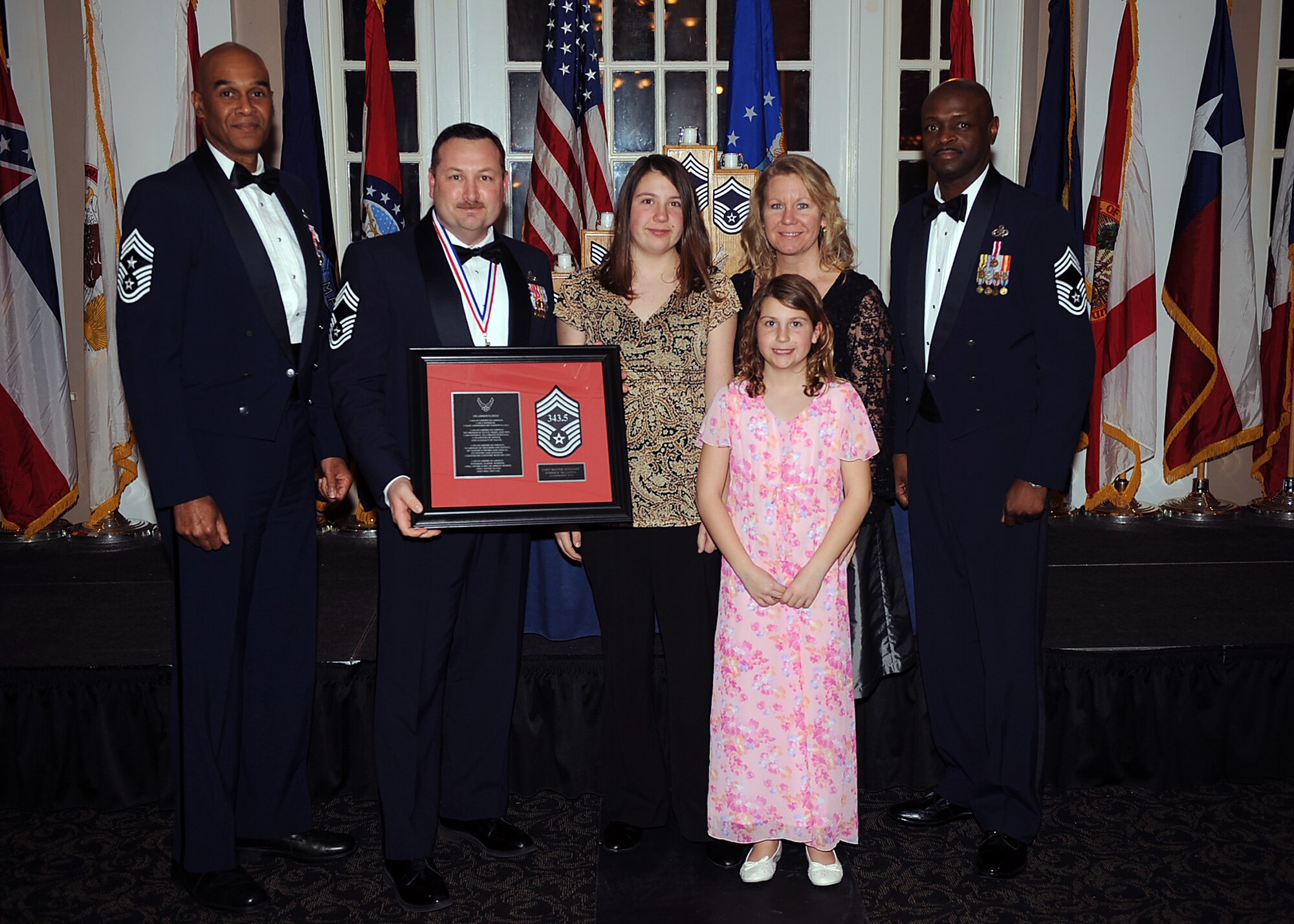 Chief Master Sgt. Dominick Tallarida, 911th Air Refueling Squadron maintenance superintendent, and his family pose with Chief Master Sgt. Leroy Frink, 4th Fighter Wing command chief, and Chief Master Sgt. Antonio Baxter, 6th Maintenance Group superintendent, MacDill Air Force Base, Fla., during the Chief Recognition Ceremony on Seymour Johnson Air Force Base, N.C., Feb. 13, 2010. Tallarida hails from Wellsboro, Pa. (U.S. Air Force photo/Senior Airman Ciara Wymbs) 