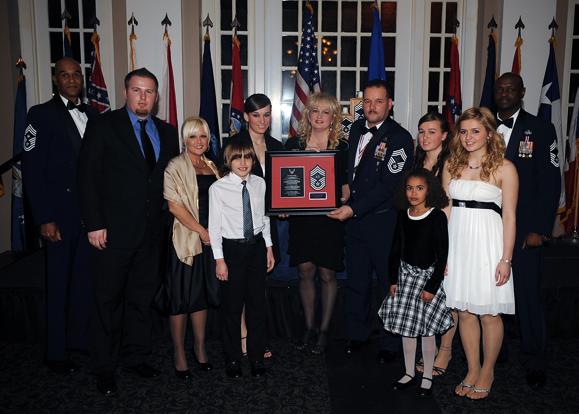 Chief Master Sgt. Kenneth Jackson, 4th Equipment Maintenance Squadron munitions production section chief, and his family pose with Chief Master Sgt. Leroy Frink, 4th Fighter Wing command chief, and Chief Master Sgt. Antonio Baxter, 6th Maintenance Group superintendent, MacDill Air Force Base, Fla., during the Chief Recognition Ceremony on Seymour Johnson Air Force Base, N.C., Feb. 13, 2010. Jackson hails from Jamestown, N.Y. (U.S. Air Force photo/Senior Airman Ciara Wymbs) 