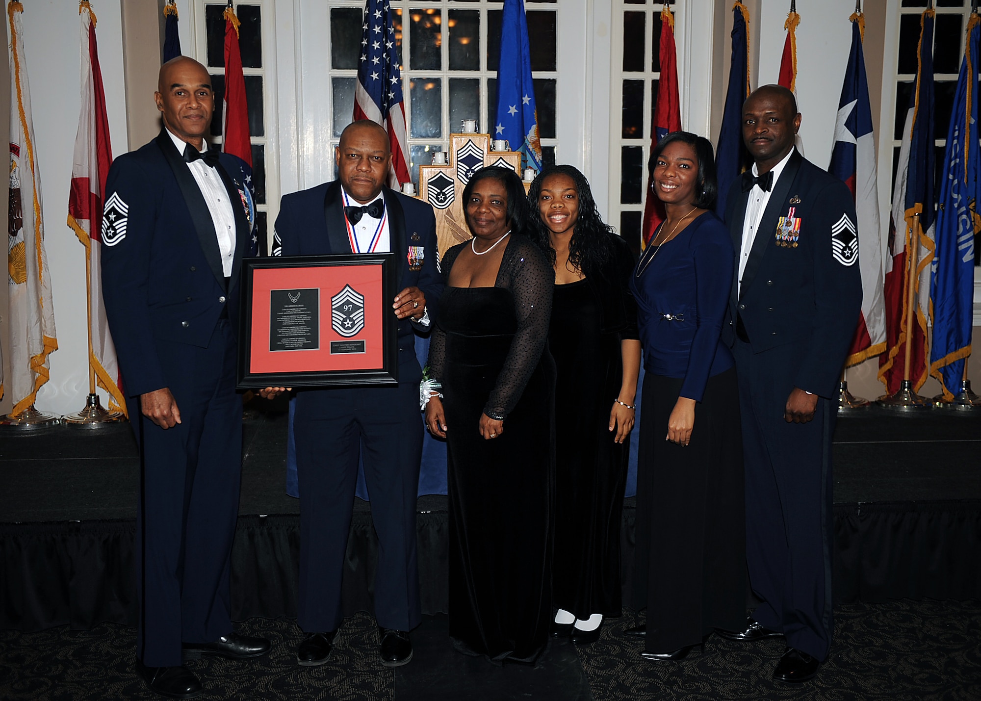 Senior Master Sgt. Larry Polite, 911th Air Refueling Squadron maintenance operations flight superintendent, and his family pose with Chief Master Sgt. Leroy Frink, 4th Fighter Wing command chief, and Chief Master Sgt. Antonio Baxter, 6th Maintenance Group superintendent, MacDill Air Force Base, Fla., during the Chief Recognition Ceremony on Seymour Johnson Air Force Base, N.C., Feb. 13, 2010. Polite hails from Manhattan, N.Y. (U.S. Air Force photo/Senior Airman Ciara Wymbs) 