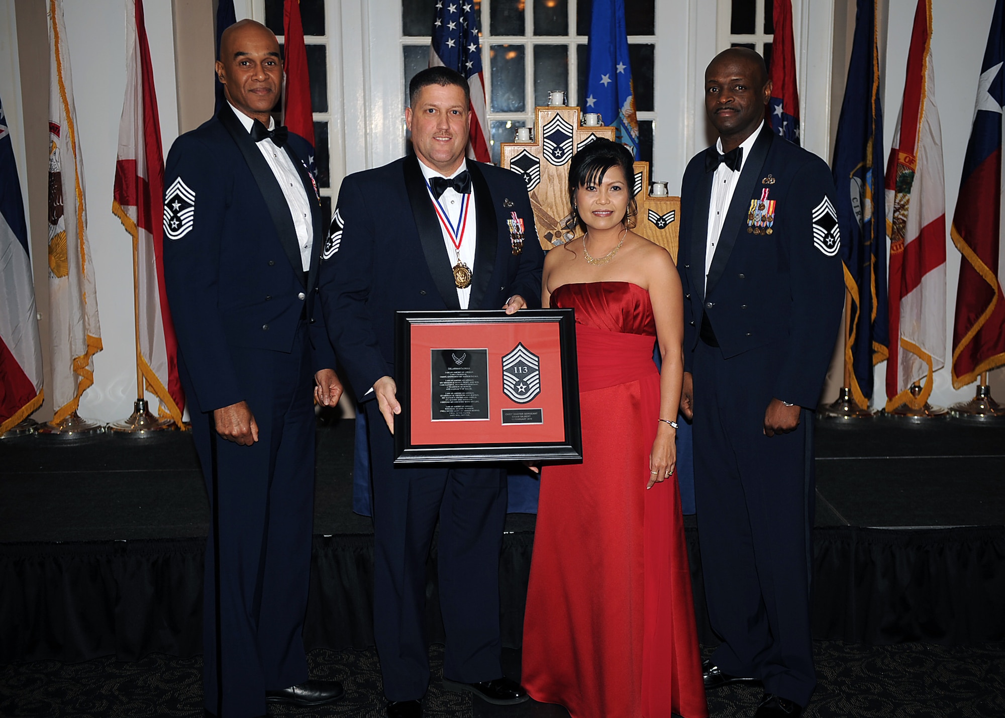 Senior Master Sgt. Brian Gilbert, 4th Maintenance Group quality assurance superintendent, and his wife Maria, pose with Chief Master Sgt. Leroy Frink, 4th Fighter Wing command chief, and Chief Master Sgt. Antonio Baxter, 6th Maintenance Group superintendent, MacDill Air Force Base, Fla., during the Chief Recognition Ceremony on Seymour Johnson Air Force Base, N.C., Feb. 13, 2010. Gilbert hails from Brevard, N.C. (U.S. Air Force photo/Senior Airman Ciara Wymbs) 