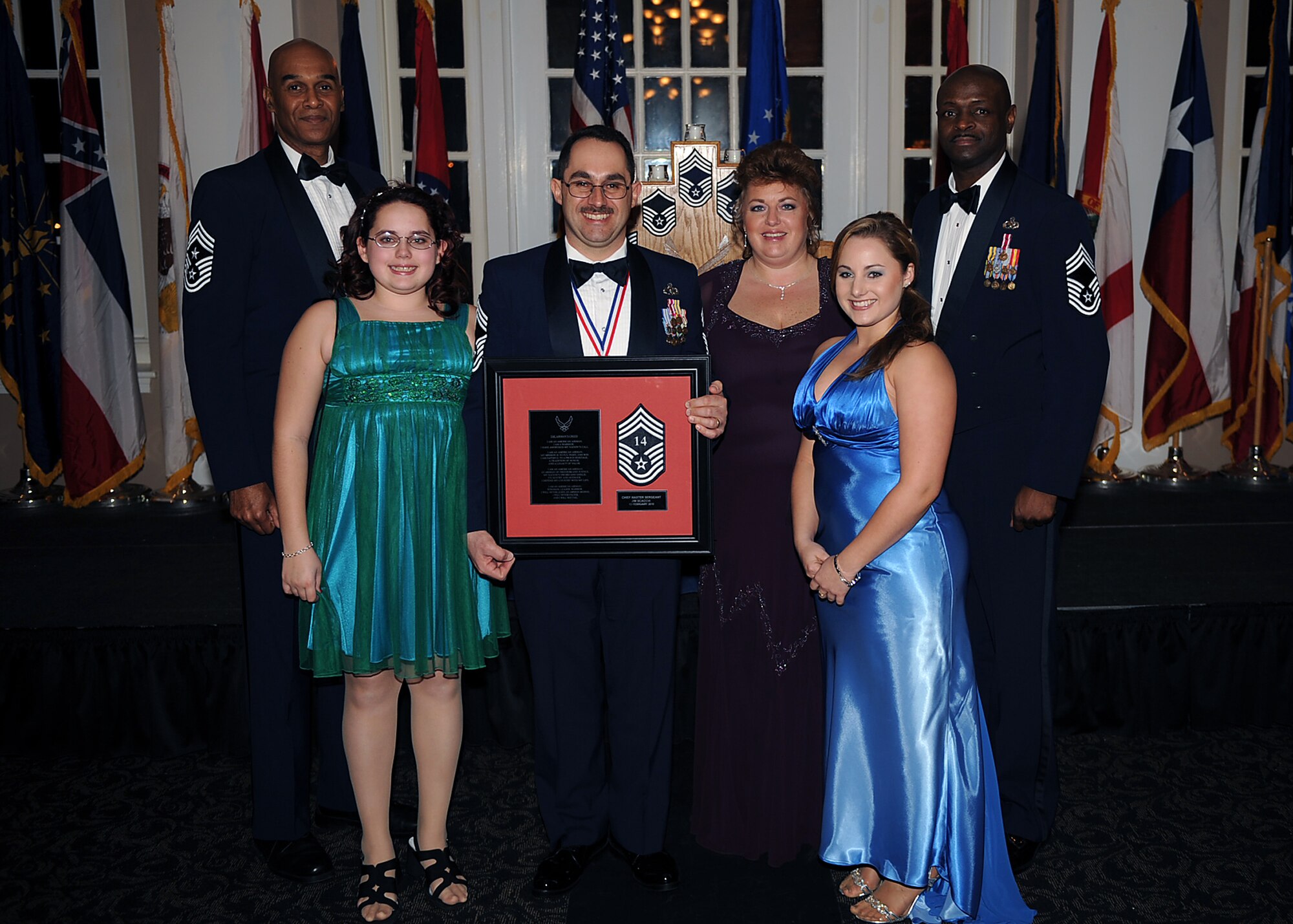 Senior Master Sgt. James Scaccia, 4th Equipment Maintenance Squadron aerospace ground equipment flight chief, and his family pose with Chief Master Sgt. Leroy Frink, 4th Fighter Wing command chief, and Chief Master Sgt. Antonio Baxter, 6th Maintenance Group superintendent, MacDill Air Force Base, Fla., during the Chief Recognition Ceremony on Seymour Johnson Air Force Base, N.C., Feb. 13, 2010. Scaccia hails from Charleroi, Pa. (U.S. Air Force photo/Senior Airman Ciara Wymbs) 