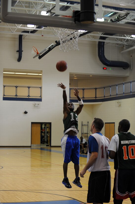 LANGLEY AIR FORCE BASE, Va. -- Ryan Center Point Guard Greg Smoots shoots the ball over Air Combat Command/A-1 command Forward Fredrick Cooper Feb. 17 at the Shellbank Fitness Center.  It was a close game for Over 30 basketball league teams, but ACC/A-1 upset the Ryan Center by one point, 47-46.  (U.S. Air Force photo/Senior Airman Zachary Wolf)