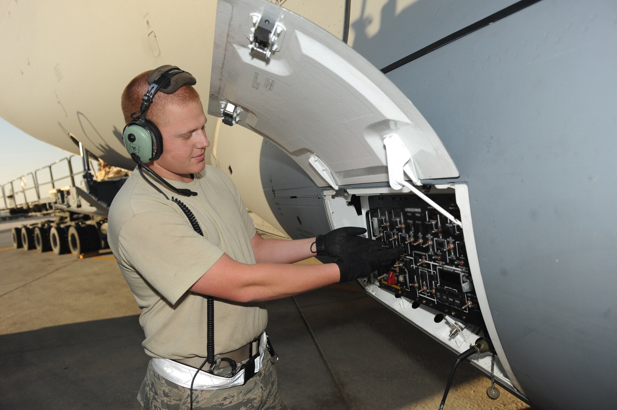 Senior Airman Samuel Schlatter, 8th Expeditionary Air Mobility Squadron auto flight controls and instruments journeyman, activates refueling switches to begin the refueling of a C-17 Globemaster III  at a non-disclosed Southwest Asia location, Feb 12, 2010. (U.S. Air Force photo by Tech. Sgt. Michelle Larche)[RELEASED]