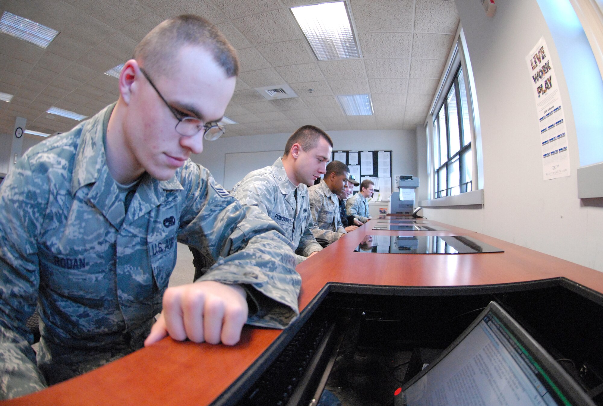 (Left) Senior Airman Todd Rodan, 512th Aircraft Maintenance Squadron, uses the computer in the new break room for 436th and 512th AMXS Airmen in Building 760. (U.S. Air Force photo/Airman 1st Class Shen-Chia Chu)