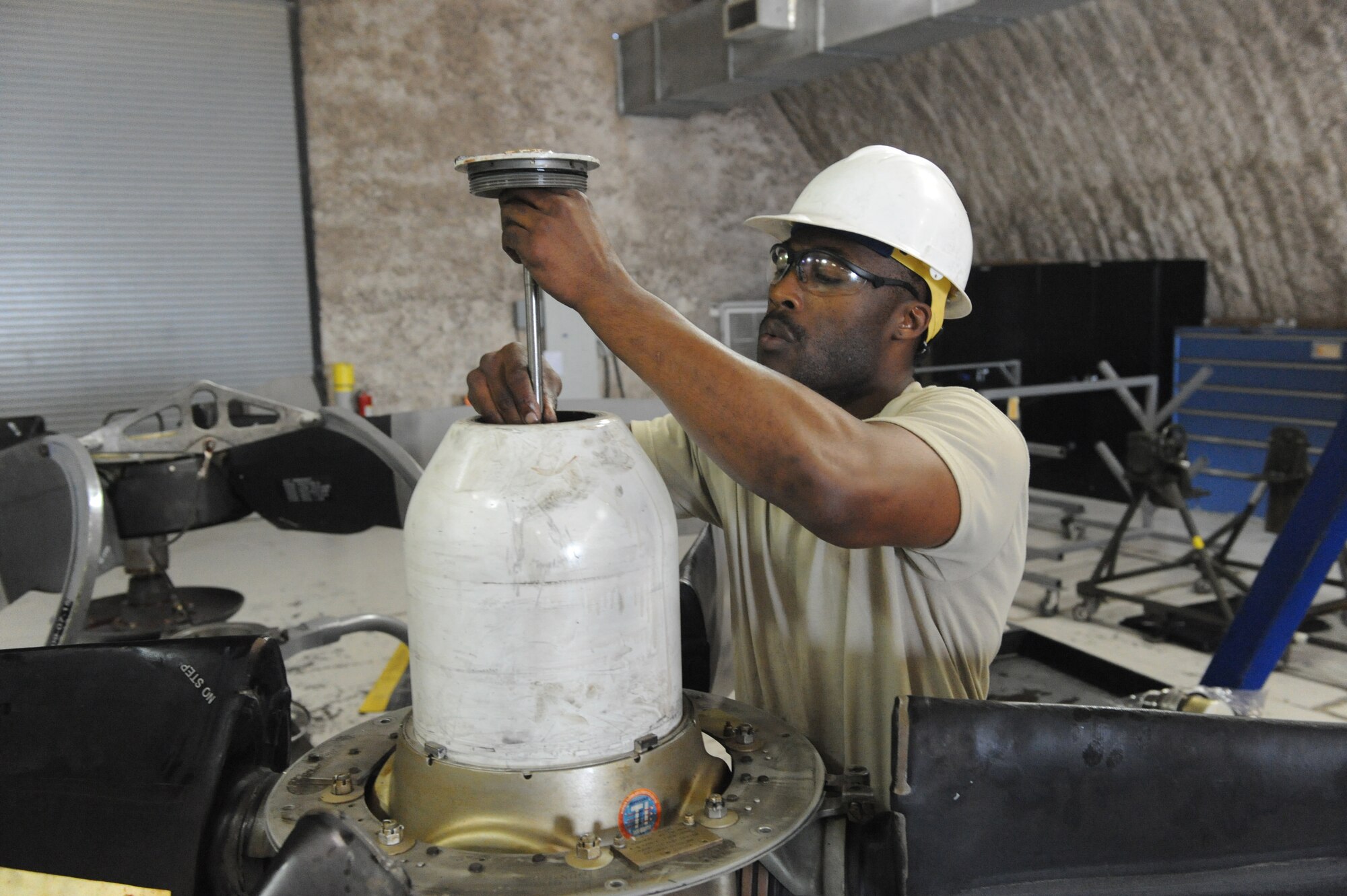 Senior Airman Terence Sharpe, 379th Expeditionary Maintenance Squadron aerospace propulsion journeyman, installs an oil transfer tube and cap assembly into a propeller, used on a C-130 engine, prior to operational testing at a non-disclosed Southwest Asia location, Feb 17, 2010. (U.S. Air Force photo by Tech. Sgt. Michelle Larche)[RELEASED]