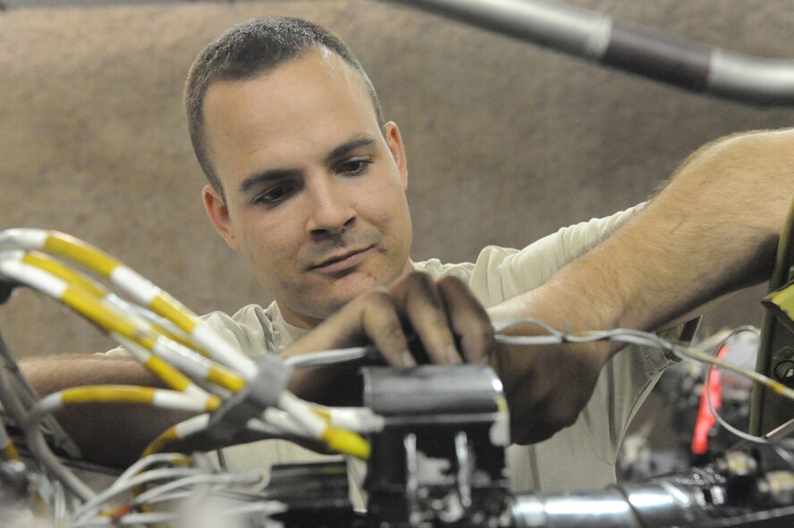 Senior Airman Dustin Phipps, 379th Expeditionary Maintenance Squadron aerospace propulsion journeyman, installs a generator cover plate on a C-130 engine at a non-disclosed Southwest Asia location, Feb 17, 2010. (U.S. Air Force photo by Tech. Sgt. Michelle Larche)[RELEASED]