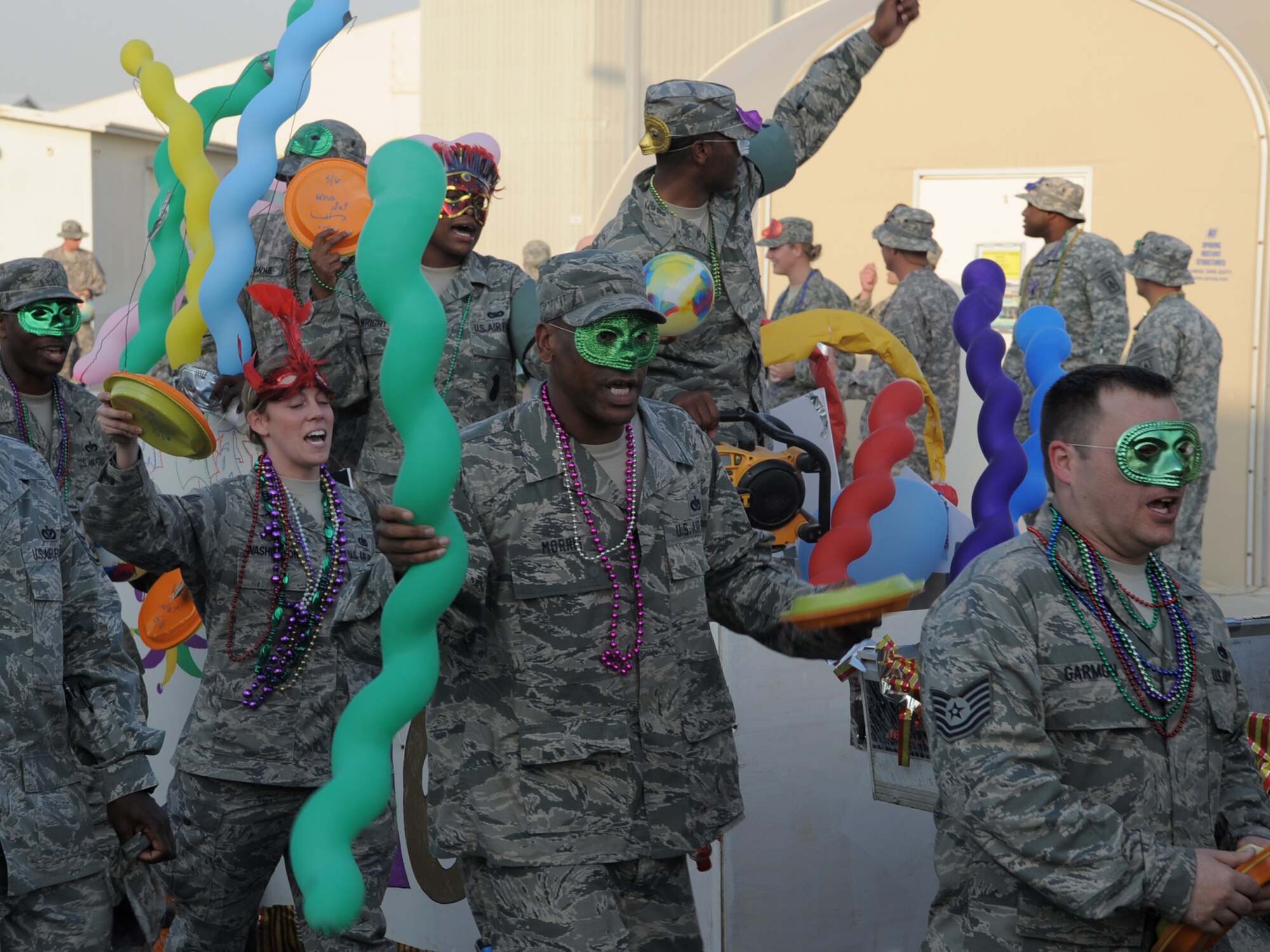 Members of the Enduring 5/6 participate in the 380th Air Expeditionary Wing Mardi Gras parade at an undisclosed location in Southwest Asia on Feb 16, 2010. The wing celebrated the holiday with a parade and cajun meal options at the dining facility.  The 380th AEW is comprised of four groups and 12 squadrons and the wing's deployed mission includes air refueling, surveillance, and reconnaissance in support of overseas contingency operations in Southwest Asia. The wing supports Operation Iraqi Freedom, Operation Enduring Freedom and the Combined Joint Task Force-Horn of Africa. (U.S. Air Force photo/Master Sgt. Scott Sturkol/Released)
