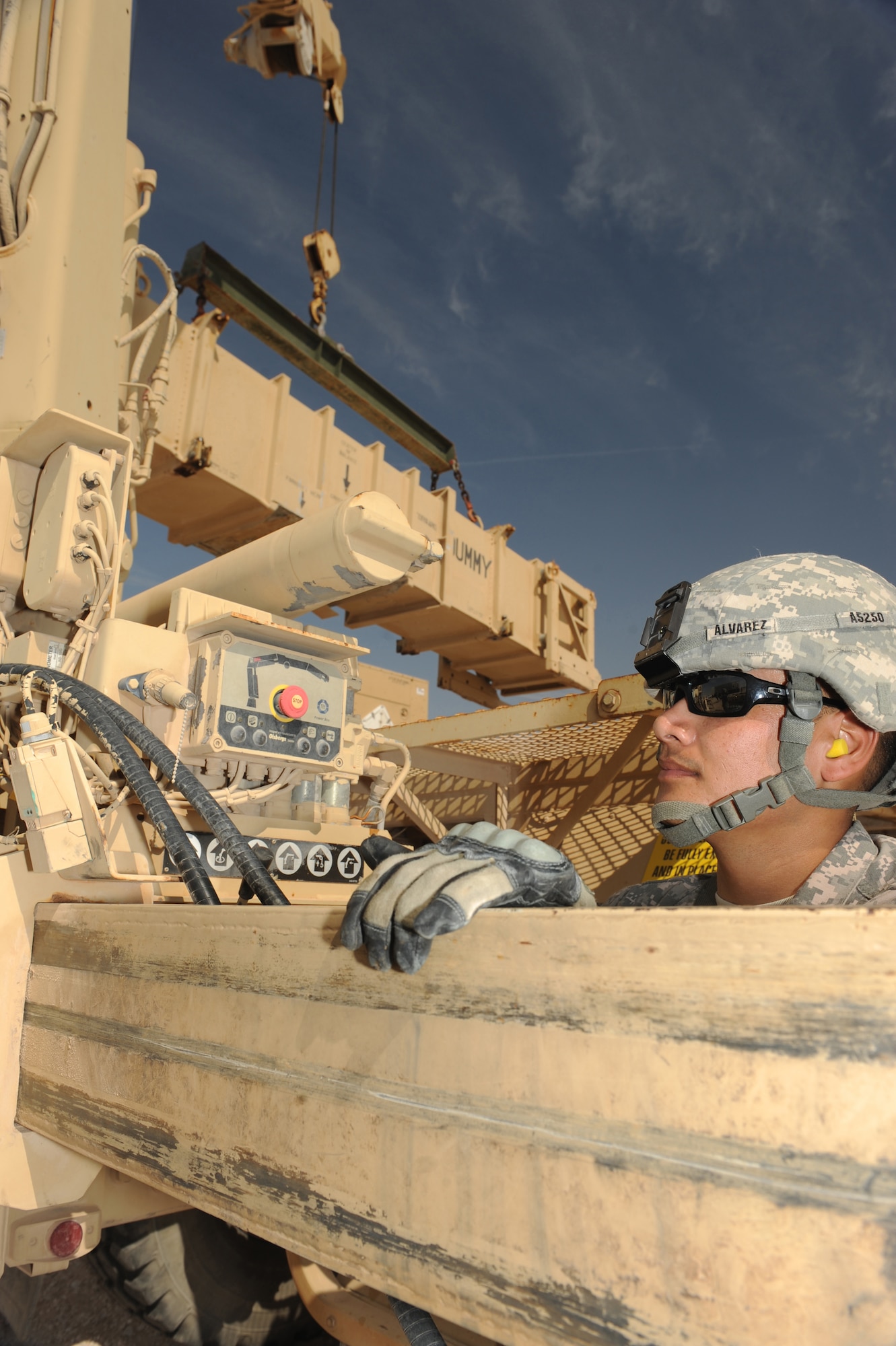 Army Sgt. Samuel Alvarez, Bravo Battery, 1-43 Air Defense Artillery, Patriot Launch Station operator/maintainer, looks for signals from teammates directing him which way to move a guided-missile transporter during a missile reload certification activity at a non-disclosed Southwest Asia location, Feb. 12, 2010. (U.S. Air Force photo by Tech. Sgt. Michelle Larche)[RELEASED]