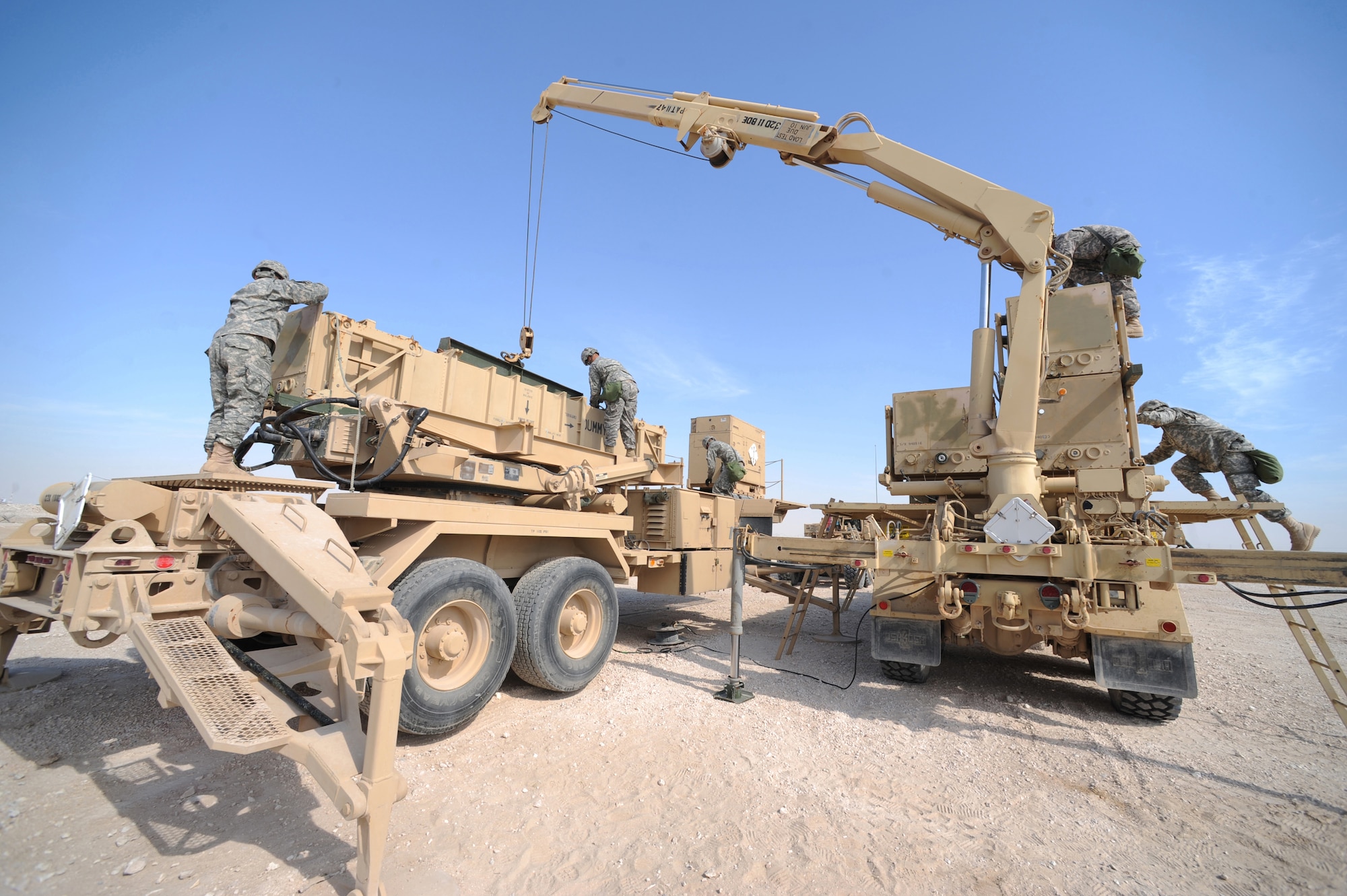 Army Patriot Launch Station operator/maintainers from Bravo Battery, 1-43 Air Defense Artillery, perform a guided-missile transporter reload certification at a non-disclosed Southwest Asia location, Feb. 12, 2010. (U.S. Air Force photo by Tech. Sgt. Michelle Larche)[RELEASED]