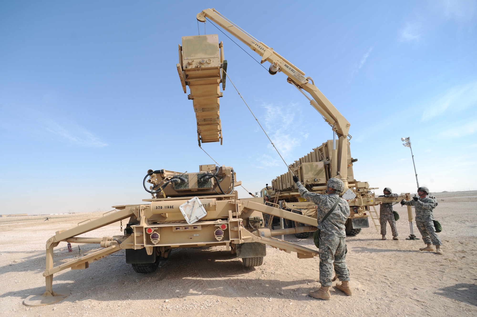 Army Patriot Launch Station operator/maintainers from Bravo Battery, 1-43 Air Defense Artillery, perform a guided-missile transporter reload certification activity at a non-disclosed Southwest Asia location, Feb. 12, 2010. (U.S. Air Force photo by Tech. Sgt. Michelle Larche)[RELEASED]