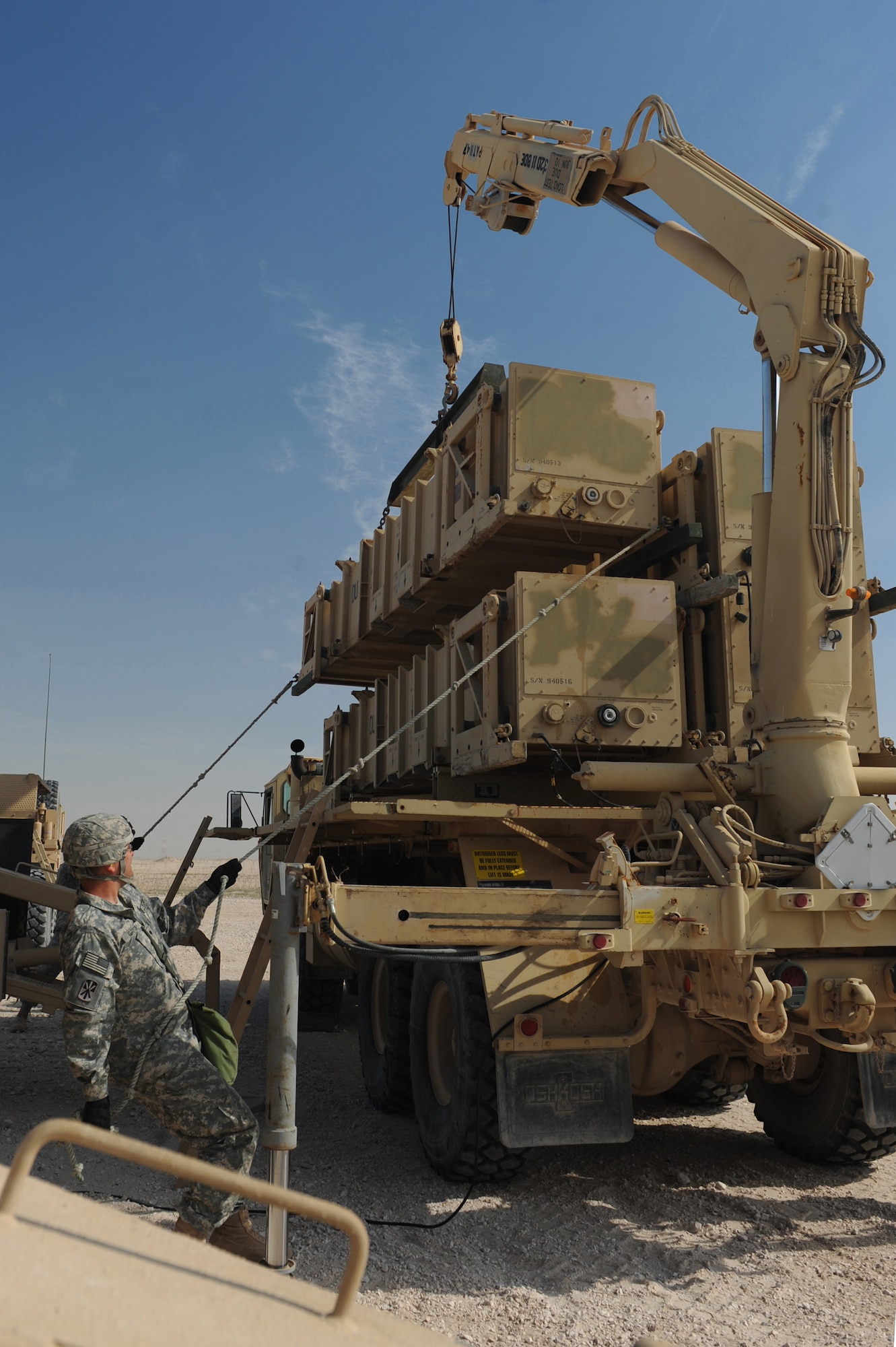 Army Spc. Alarick Garza, Bravo Battery, 1-43 Air Defense Artillery, Patriot Launch Station operator/maintainer, holds a tag line to keep a missile canister steady during a guided-missle transporter reload certification activity at a non-disclosed Southwest Asia location, Feb. 12, 2010. (U.S. Air Force photo by Tech. Sgt. Michelle Larche)[RELEASED]