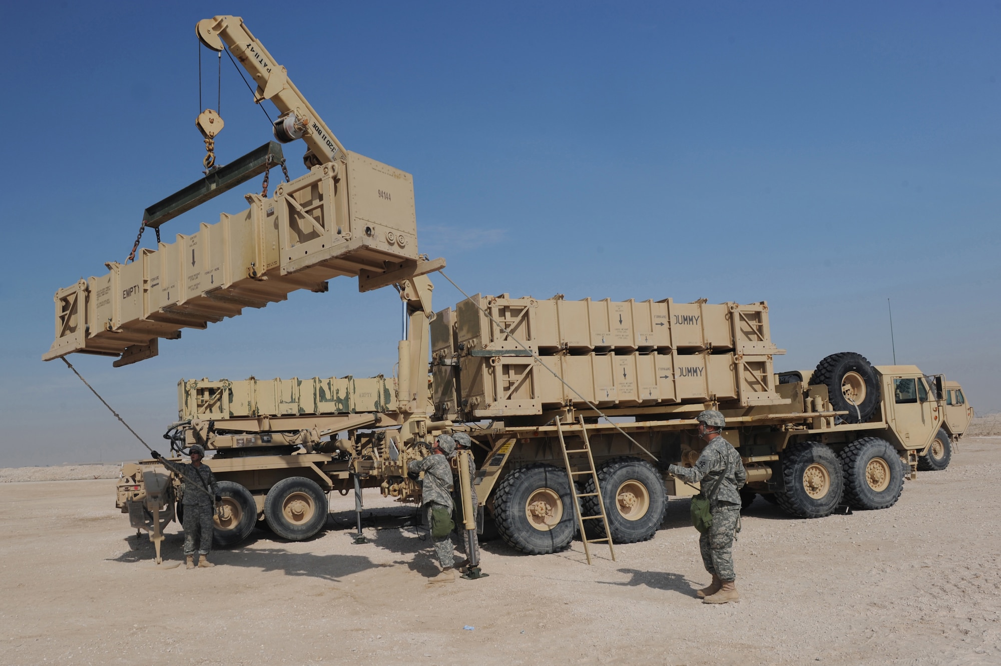 Army Patriot Launch Station operator/maintainers rom Bravo Battery, 1-43 Air Defense Artillery, hold a tag line to keep a missle canister steady during a guided-missile transporter reload certification activity at a non-disclosed Southwest Asia location, Feb. 12, 2010. (U.S. Air Force photo by Tech. Sgt. Michelle Larche)[RELEASED]