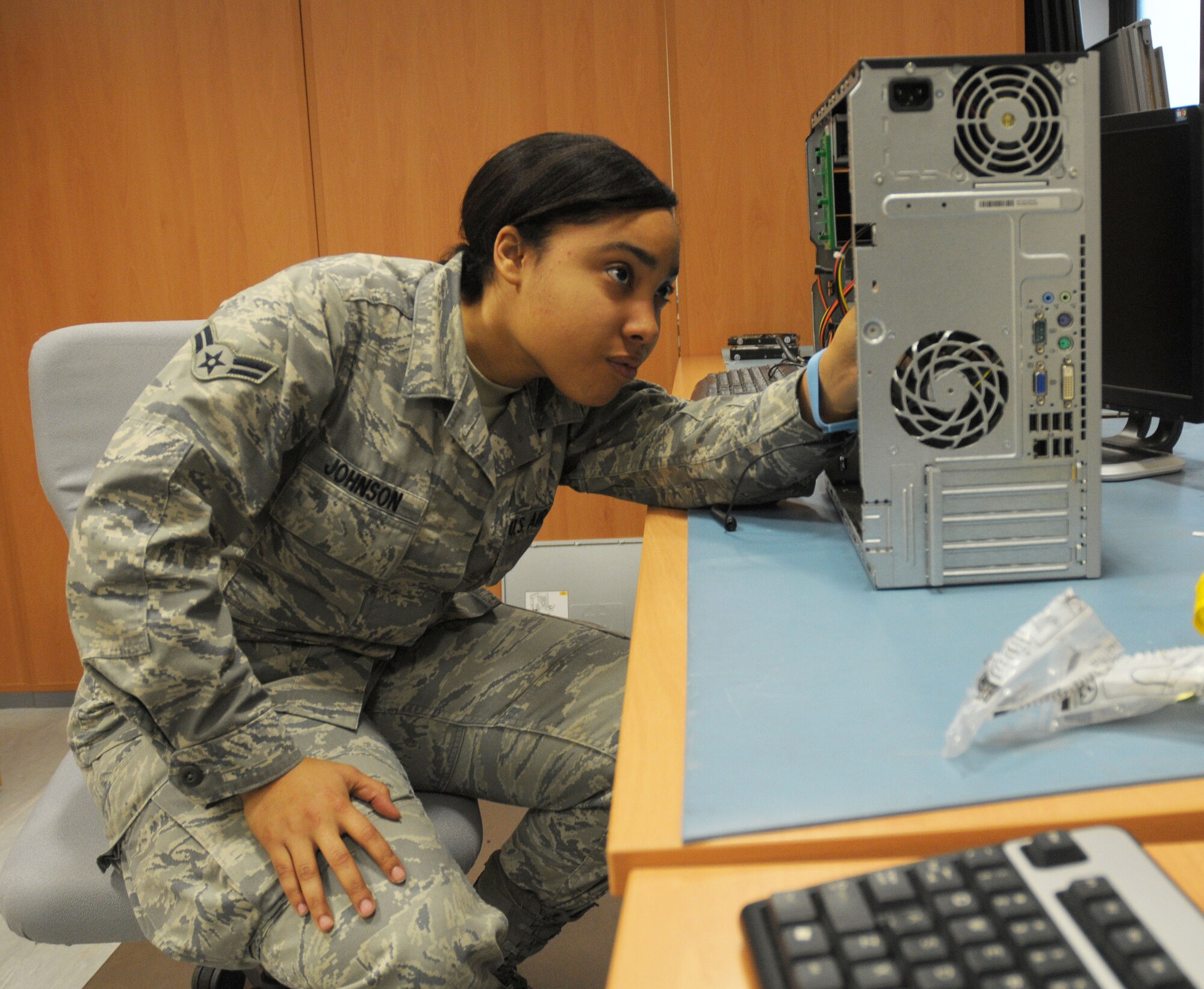 Airman 1st Class Ashleigh Johnson, 48th Communications Squadron client support technician, works on a computer tower at RAF Lakenheath, England, Feb. 17. She was nominated for the Liberty Spotlight by her chain of command because she demonstrates the Air Force core value of "Excellence in All We Do." (U.S. Air Force photo by Staff Sgt. Connor Estes) 