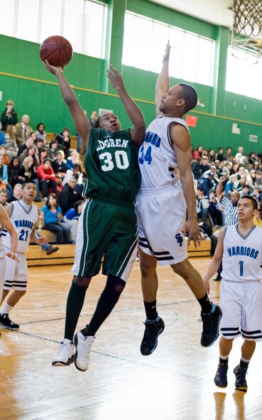 MISAWA AIR BASE, Japan -- James Ervin, Edgren Eagles guard, attempts a layup over Isaac Berk, St. Paul Warriors forward, during a Far East Basketball Tournament game Feb. 18 at Edgren High School. Ervin contributed 10 points in the 83 - 69 win over the Warriors. (U.S. Air Force photo/Senior Airman Jamal D. Sutter)