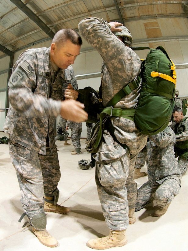 U.S. Army Col. Mark R. Stammer, left, performs a jumpmaster personnel ...