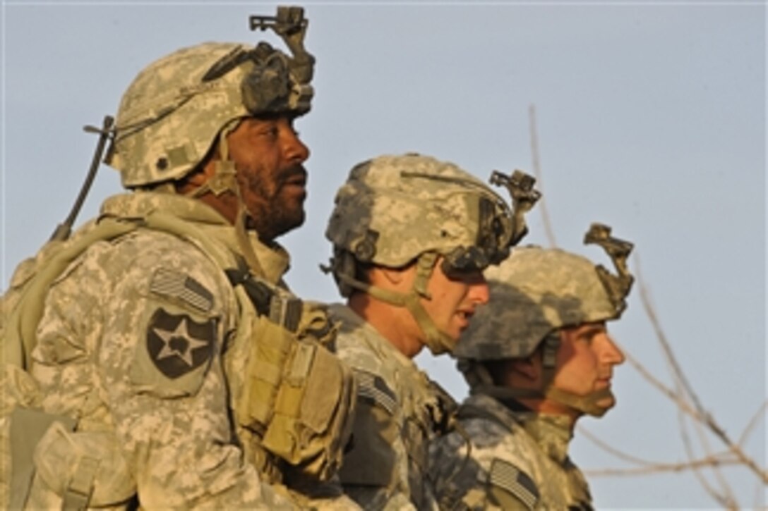 U.S. Army Sgts. Keith Bradley, Arthur Troche and Anthony Roney, all with Alpha Company, 1st Battalion, 17th Infantry Regiment, scan the horizon for enemy movement during Operation Helmand Spider in Badula Qulp, Helmand province, Afghanistan, on Feb. 9, 2010.  