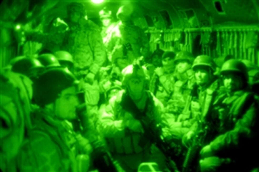 As seen through a night-vision device, U.S. Marines and Afghan security forces are packed to capacity with 39 troops onboard a U.S. Army CH-47F Chinook helicopter before their assault into Marja in Helmand province, Afghanistan, Feb. 13, 2010. Twelve U.S. Army helicopters inserted almost 300 Marines and Afghan forces, kicking off Operation Moshtarak. The Marines are assigned to Kilo Company, 3rd Battalion, 6th Marine Regiment.