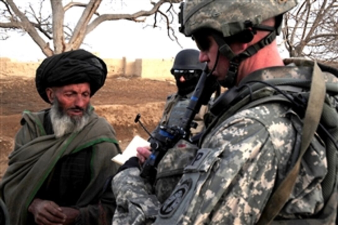 U.S. Army Sgt. Shaun Amend talks with a village elder about recent activity in the area of Surkabad, Logar province, Afghanistan, Feb. 13, 2010. Amend is assigned to the 118th Military Police Company, which is attached to the 173rd Airborne Brigade Combat Team. 