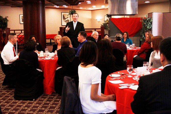 Dave Garber, a station protocol officer, gives instruction on dinning etiquette to a group of community members who attended the Dine Like a Diplomat intructional class at the Talbot dinning room here Feb. 19. Approximately 20 local community members attended the class which instructed them on the proper way to seat themselves at a table, how to use a knife and fork and how to conduct themselves throught a formal dinner setting.