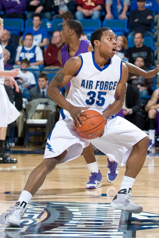 Falcon junior guard Evan Washington drives for 2 of his team leading 16 points against the Texas Christian University Horned Frogs Feb. 6, 2010, at the Academy's Clune Arena. The Falcons fell short of their goal, losing to TCU by a score of 65-51.  (U.S. Air Force photo/Bill Evans)