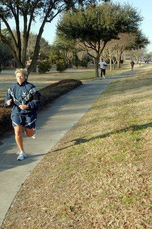 Master Sgt. Kristina Mullins leads the way for the females as she prepares to cross the finish line during the monthly commander's fitness challenge Feb. 19, 2010, at Joint Base Charleston, S.C. Sergeant Mullins was the first place finisher in the female category with a time of 23:14. Sergeant Mullins is assigned to the 15th Airlift Squadron. (U.S. Air Force photo/Staff Sgt. Marie Brown)
