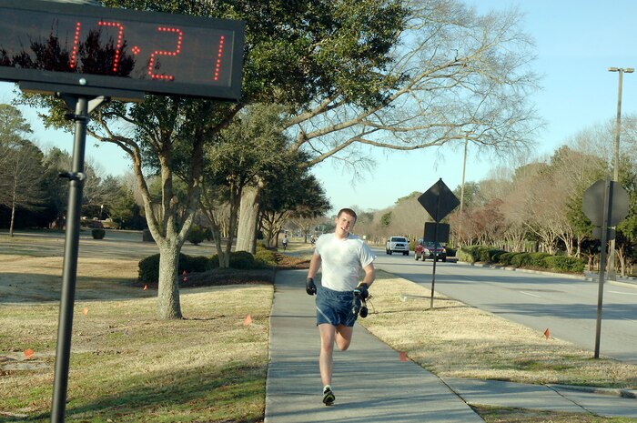 Second Lt. Ryan Peake crosses the finish line during the monthly commander's fitness challenge Feb. 19, 2010, at Joint Base Charleston, S.C. Lieutenant Peake was the first place finisher in the male category with a time of 17:21. Lieutenant Peake is assigned to the 628th Force Support Squadron. (U.S. Air Force photo/Staff Sgt. Marie Brown)