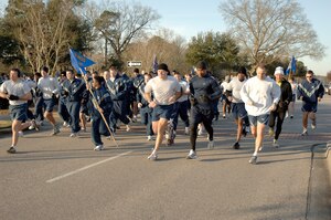 Members of Joint Base Charleston take off from the starting line at the beginning of the monthly commander's fitness challenge Feb. 19, 2010, at Joint Base Charleston, S.C. This month's fitness challenge kicked off Military Saves Week which runs from Feb. 21 through 28 to persuade, motivate, and encourage military families to save money every month. (U.S. Air Force photo/Staff Sgt. Marie Brown)