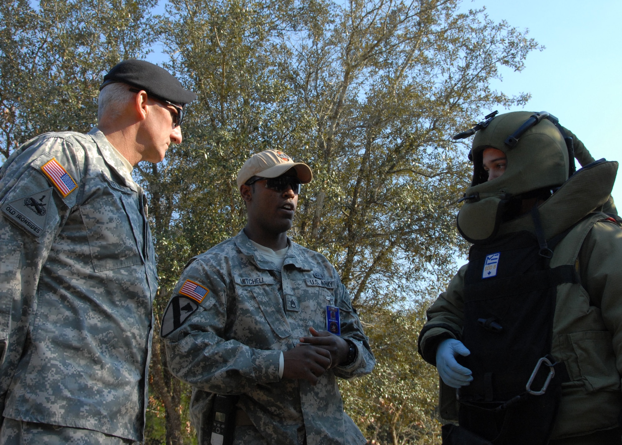 Army Staff Sgt. Thomas Mitchell, Navy Explosive Ordnance Disposal school instructor, briefs Lt. Gen. Mark Hertling on a demonstration while an Army trainee waits to execute, Feb. 17.  The general, in charge of initial military training for the U.S. Army, visited the school to get a first-hand look at EOD training.  Soldiers account for 60 percent of the school’s attendance.  (U.S. Air Force photo/Samuel King Jr.)