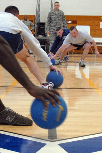 EGLIN AIR FORCE BASE, Fla. –  Players rush to the grab their “ammunition” during a dodge ball tournament at the Eglin Fitness Center, Feb. 19. Nine five-member teams competed to become the dodge ball champs in double-elimination rounds. The “Cops” team came out victorious beating the “Family First” team twice in the championship match. (U.S. Air Force photo/ Airman 1st Class Anthony Jennings)