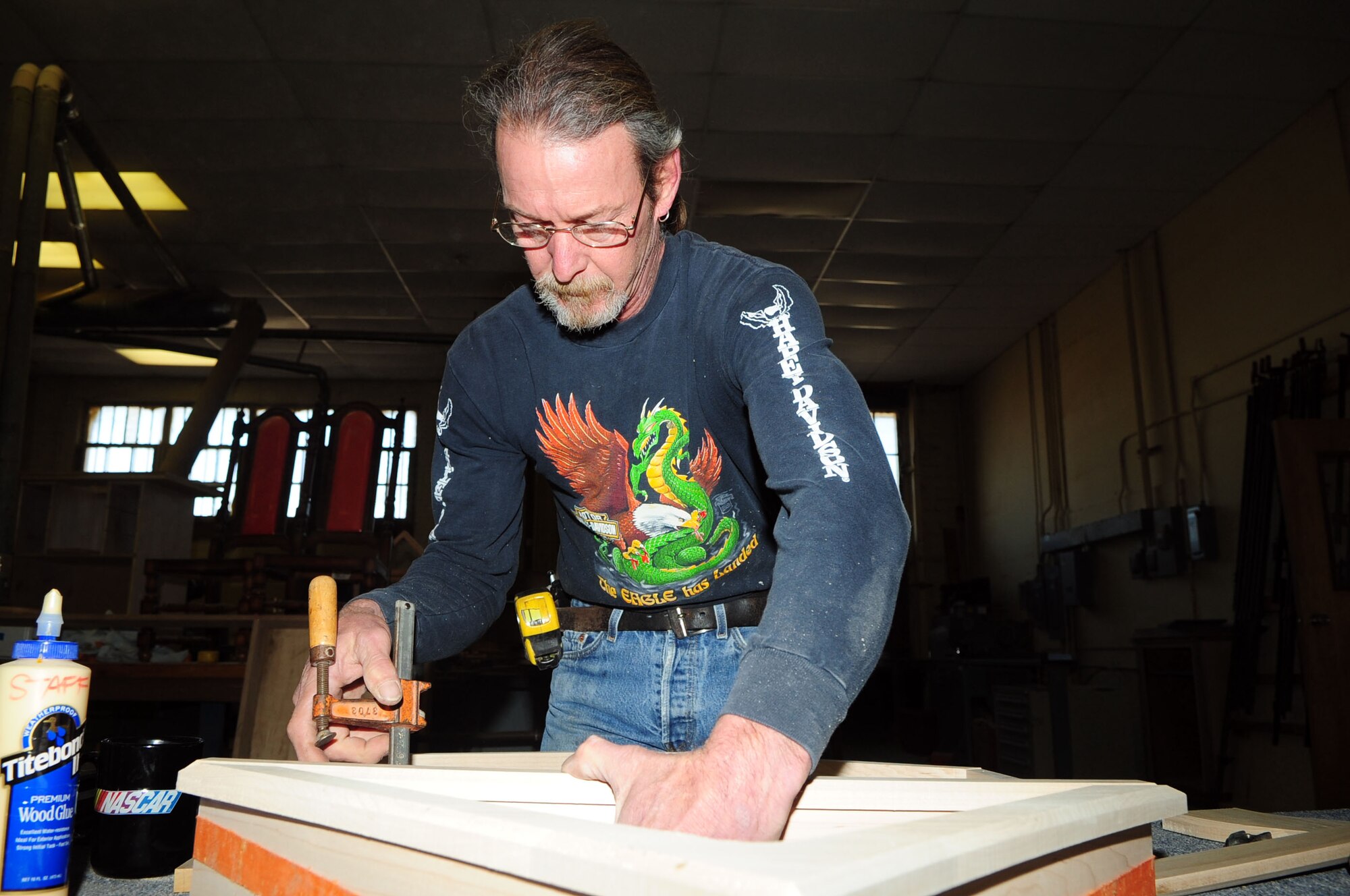 BARKSDALE AIR FORCE BASE, La. -- Mike Jarrett, 2d Force Support Squadron wood craftsman glues together a shadow box, Feb. 19. Mr. Jarrett has been at the wood hobby shop since 1994, when he was a carpenter in the Air Force. (U.S. Air Force photo by Senior Airman Joanna M. Kresge)