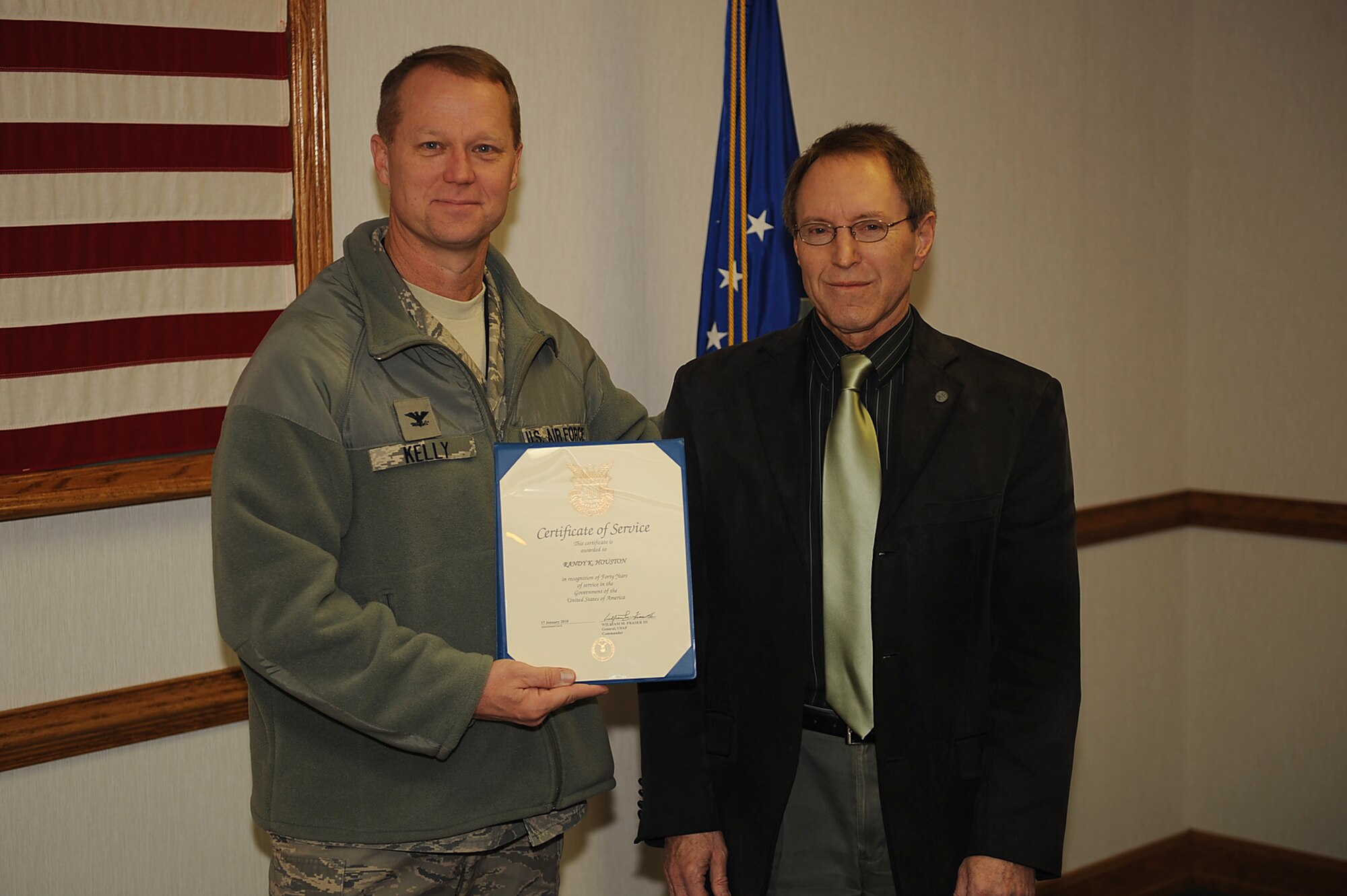 Col. Mark Kelly, 4th Fighter Wing commander, presents Randy Houston, 4th Force Support Squadron civilian personnel officer, a certificate of service on Seymour Johnson Air Force Base, N.C., Feb. 18, 2010. Houston is from Richlands, N.C., and is being honored for 40 years of DoD service. (U.S. Air Force photo/Senior Airman Ciara Wymbs) 