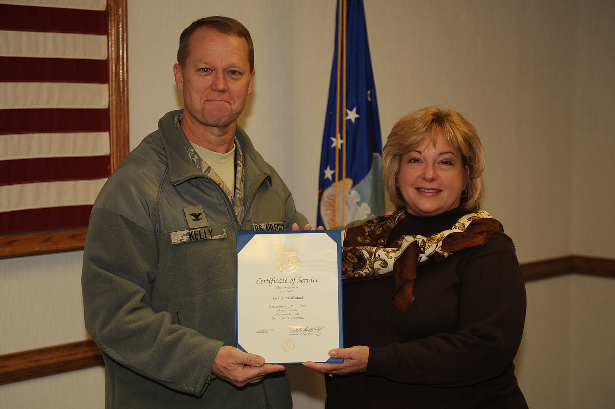 Col. Mark Kelly, 4th Fighter Wing commander, presents Linda Edsall-Huard, 4th Force Support Squadron deputy, a certificate of service on Seymour Johnson Air Force Base, N.C., Feb. 18, 2010. Edsell-Huard is from Washington, D.C., and is being honored for 30 years of DoD service. (U.S. Air Force photo/Senior Airman Ciara Wymbs) 