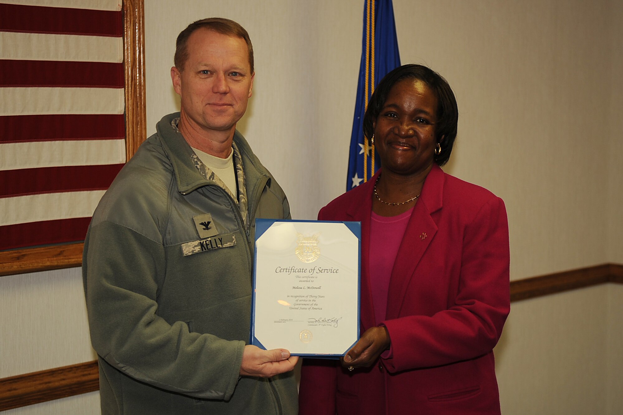 Col. Mark Kelly, 4th Fighter Wing commander, presents Melissa McDowell, 4th Force Support Squadron human resources assistant, a certificate of service on Seymour Johnson Air Force Base, N.C., Feb. 18, 2010. McDowell is from Georgetown, S.C. and is celebrating 30 years of DoD service. (U.S. Air Force photo/Senior Airman Ciara Wymbs) 