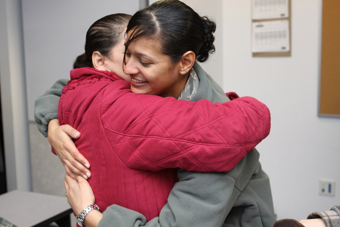 U.S. Air Force Senior Airman Erica Aybar-Morillo hugs her mother before deploying.  Family members said their good-byes as more than 30 177th Security Forces Airmen from the 177th Fighter Wing deployed to Southwest Asia on Feb. 9, 2010.  U.S. Air Force Photo by Tech. Sgt. Mark Olsen, 177FW/PA.