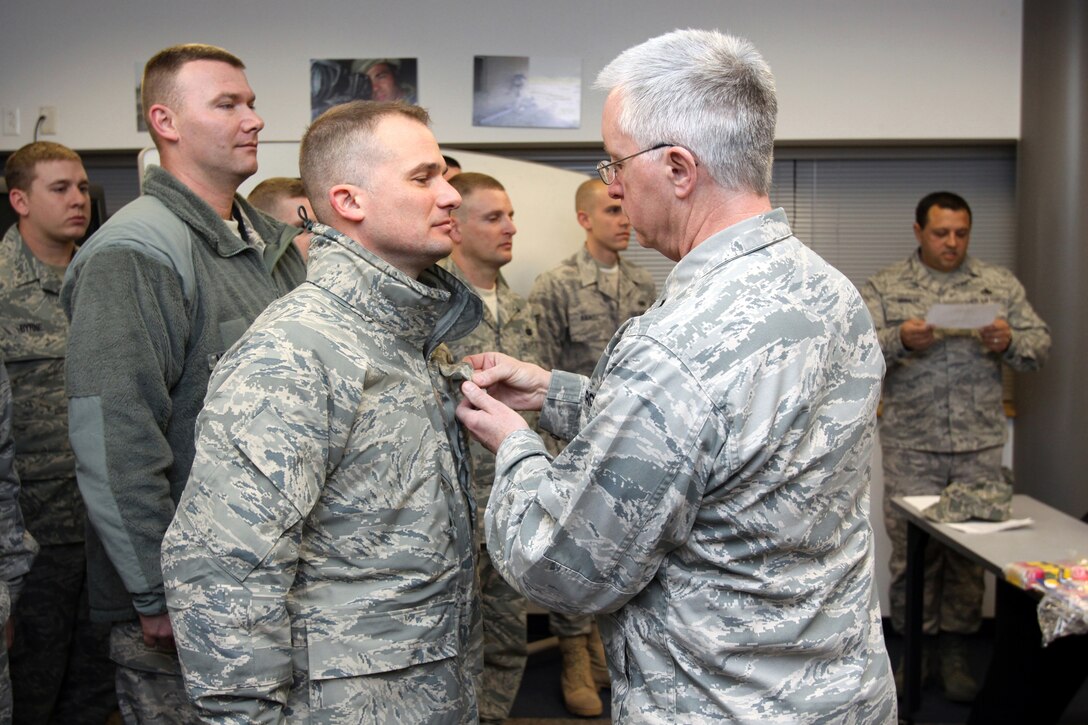 U.S. Air Force Lt. Col. Michael K. Love, second from right, 177th Fighter Wing Mission Support Group Commander, promotes deploying Senior Master Sgt. Michael P. Allen, third from left, to Chief Master Sergeant. More than 30 177th Security Forces Airmen from the 177th Fighter Wing deployed to Southwest Asia on Feb. 9, 2010.  U.S. Air Force Photo by Tech. Sgt. Mark Olsen, 177FW/PA.
