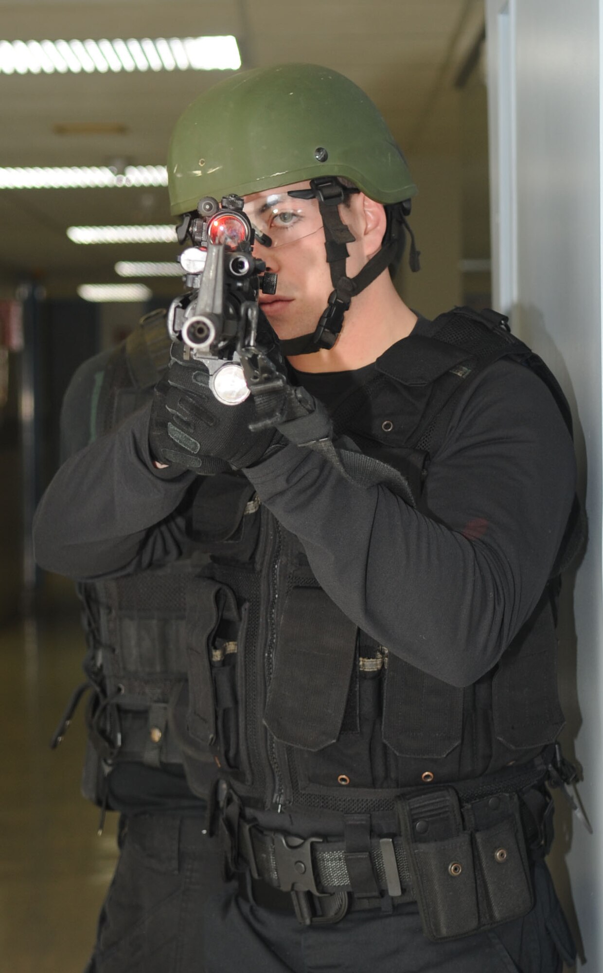 BARKSDALE AIR FORCE BASE, La. – Airman 1st Class Timothy Ferraro, 2d Security Forces Squadron, Emergency Services Team member takes aim down an abandoned hallway while his team clears a room Feb. 18. The squad trains once a week with a full day of training once a month. (U.S. Air Force photo by Senior Airman Alexandra Longfellow) (RELEASED)